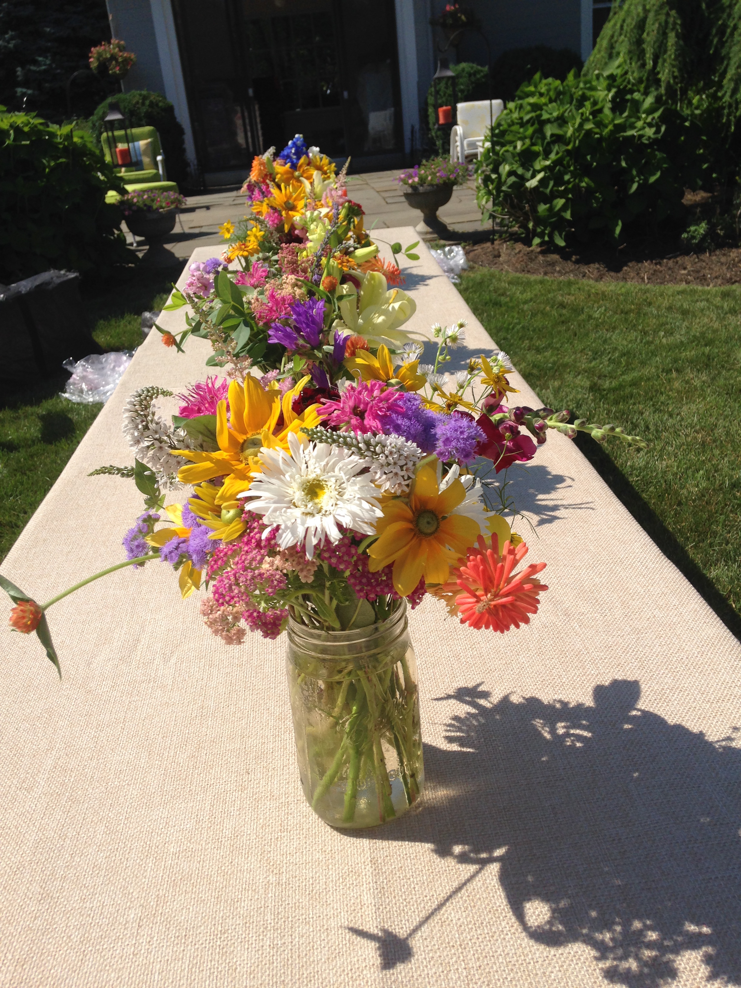 Mason jars full of gorgeous blossoms look great on burlap or on linens with burlap runners.