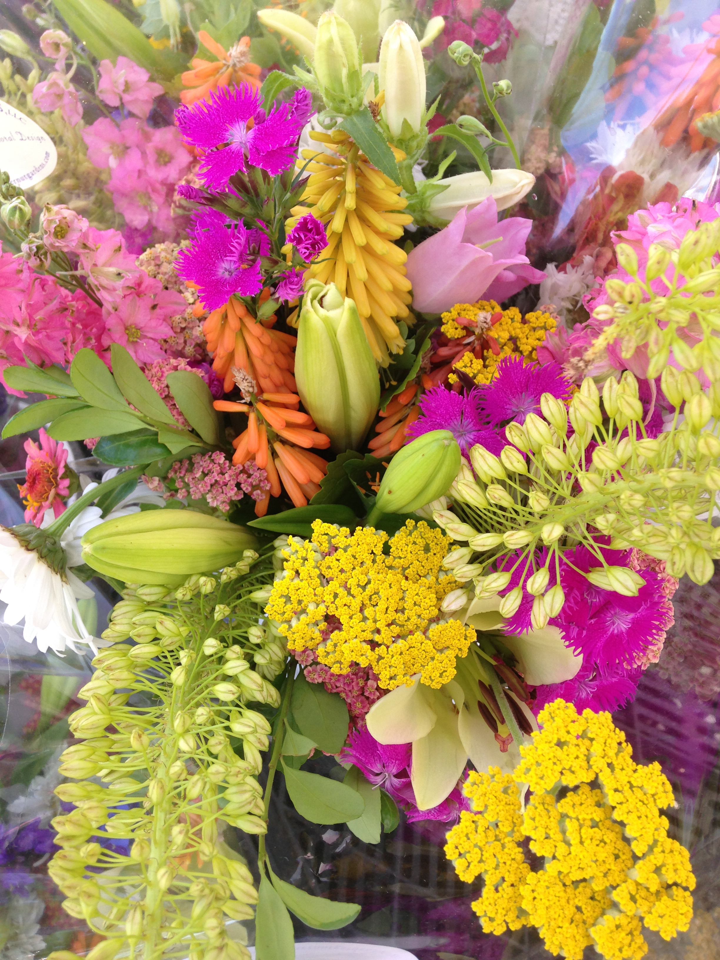 The bright yellow yarrow in lower right puts real zip into any bouquet. Yellow and orange red hot pokers can be seen in the center of this grouping.