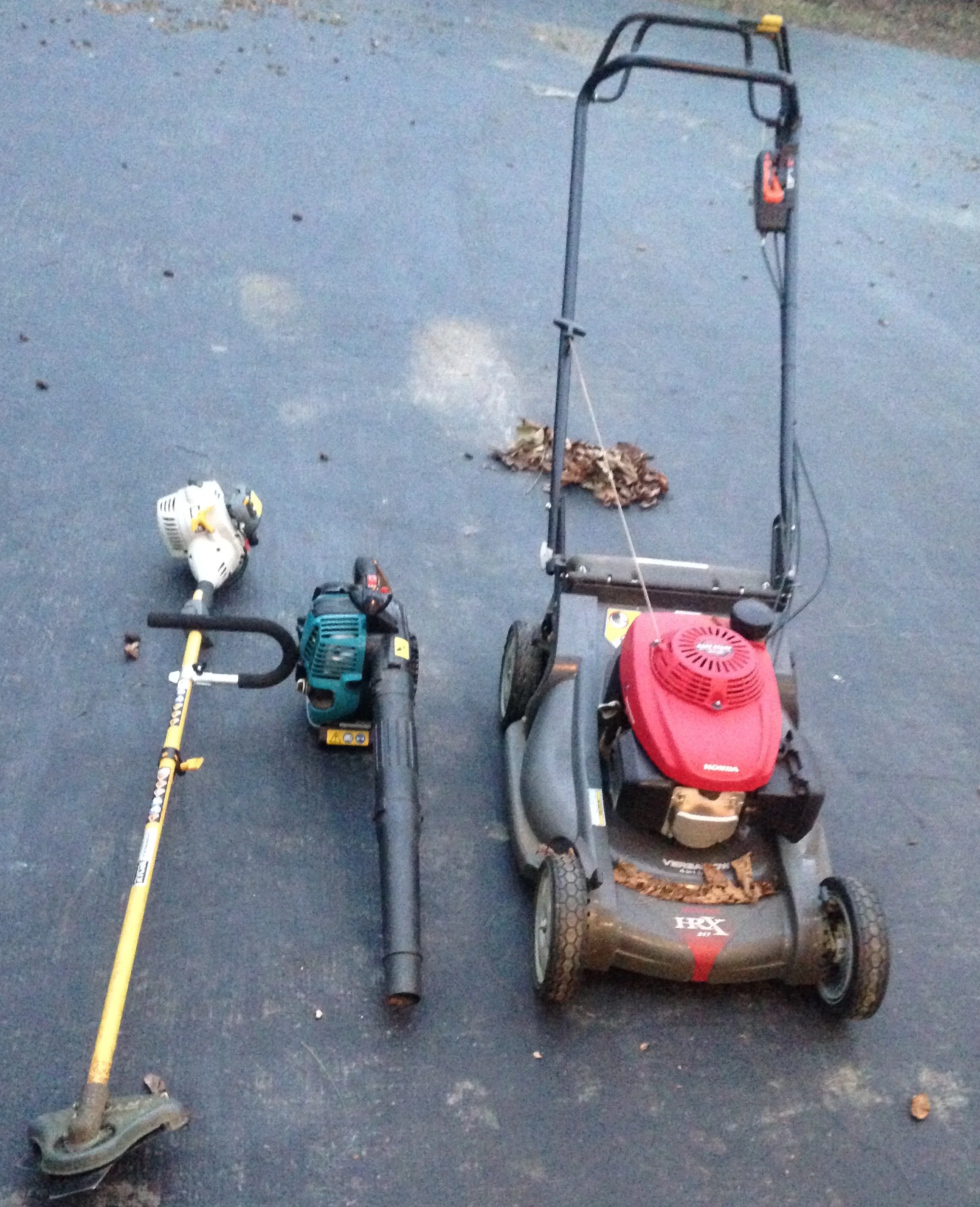 My go-to equipment for keeping my leaves on site: weed whacker, leaf blower, and hand mower.