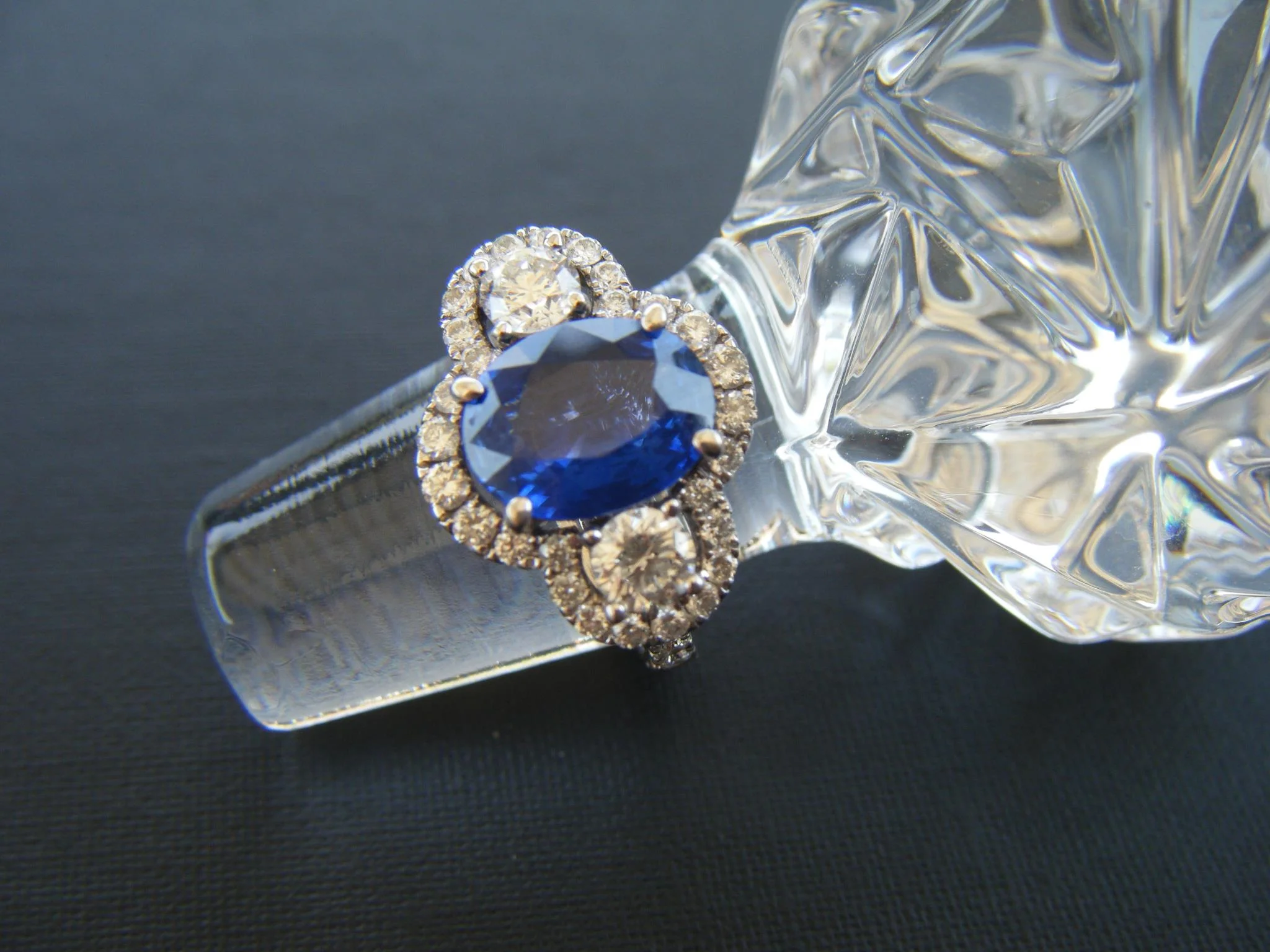 SOLD - Beautiful diamond and sapphire ring with a 2.03 carat sapphire in the center and a 0.44 carat diamond on each side set in 18K white gold. 