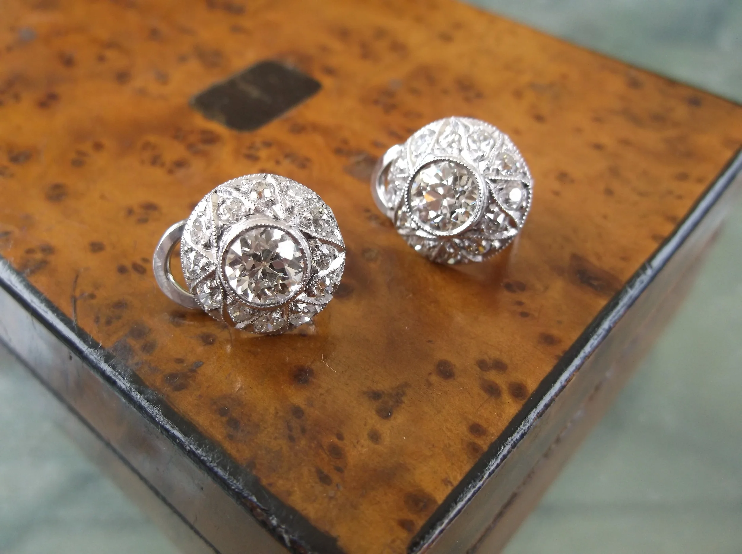 SOLD - Gorgeous Art Deco diamond and platinum earrings with a 0.90 carat Old European cut diamond in the center of each.