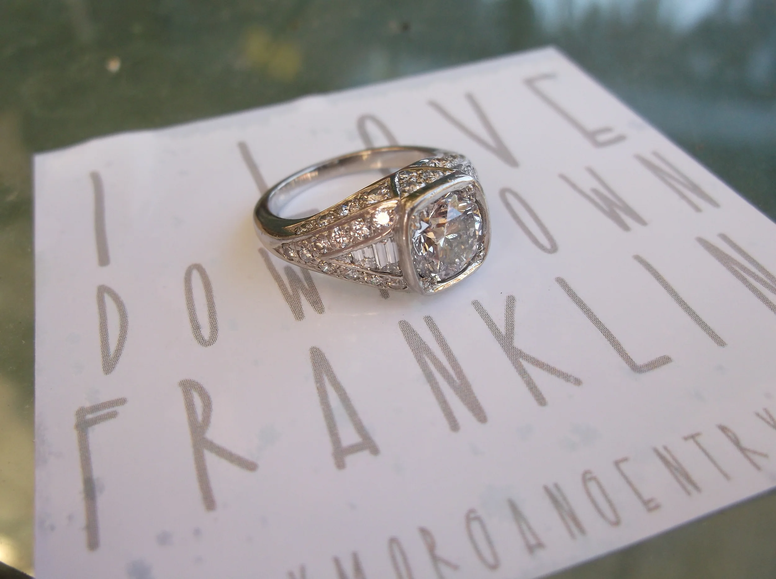 SOLD - Breathtaking 1.58 carat round brillant diamond set in platinum mounting with round and baguette diamond detail.