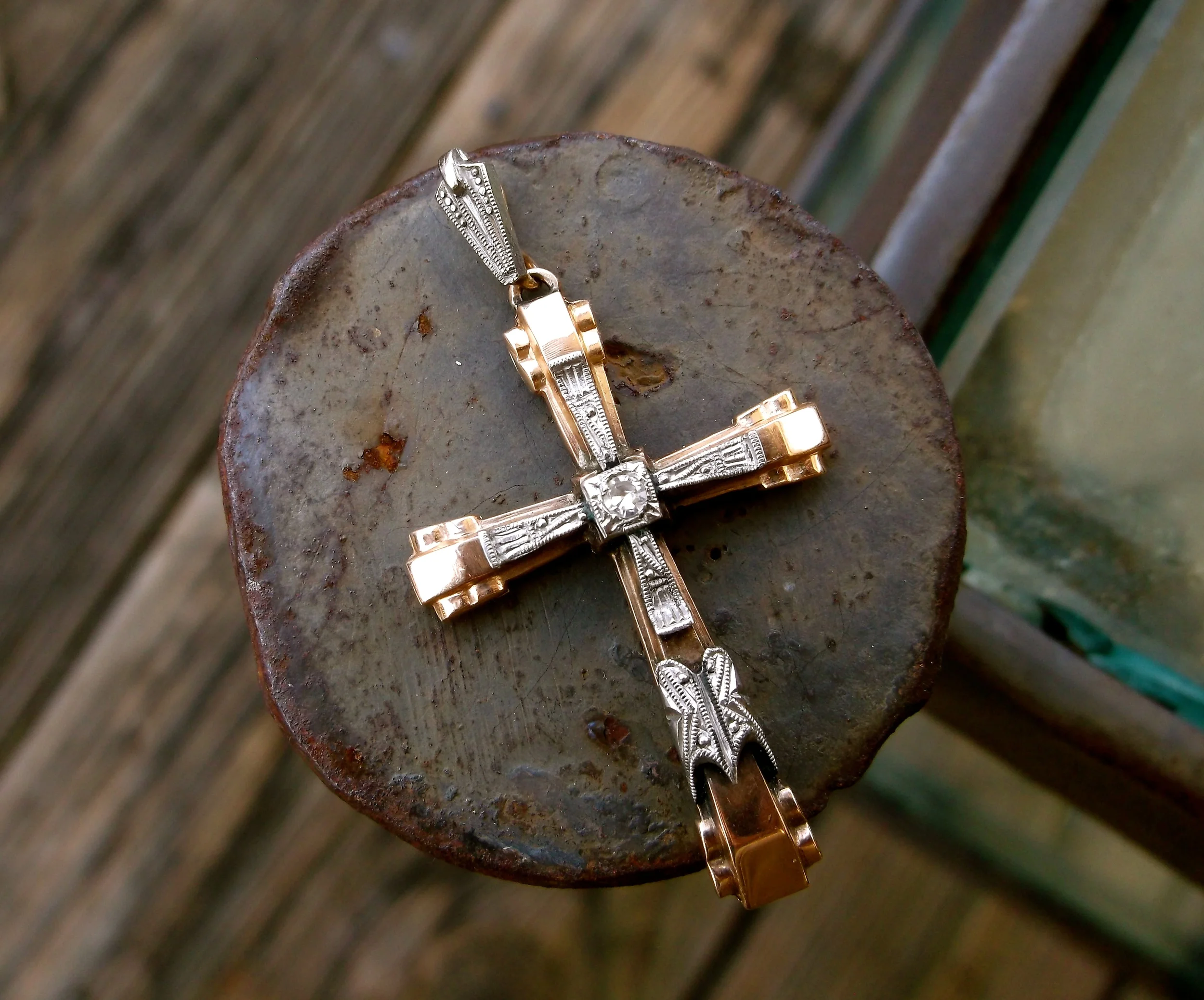 Edwardian white gold on yellow gold cross with a diamond in the center. 