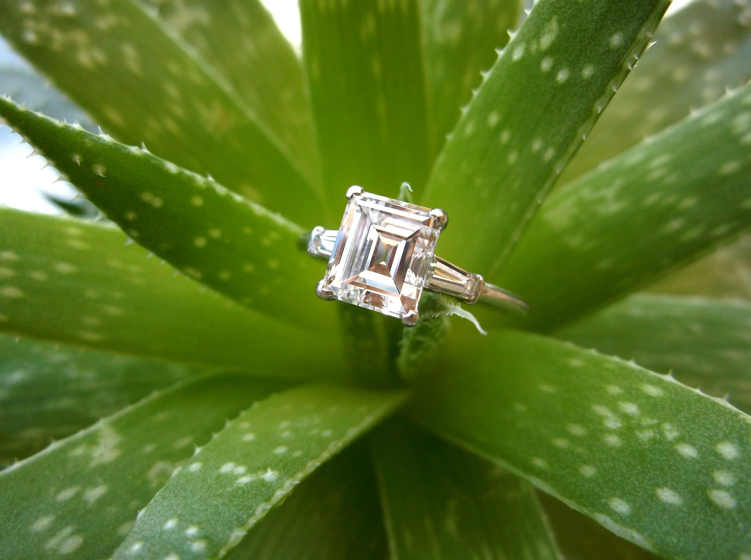 SOLD - Breathtaking 1.80 carat step cut diamond set in platinum with a baguette diamond on either side. 