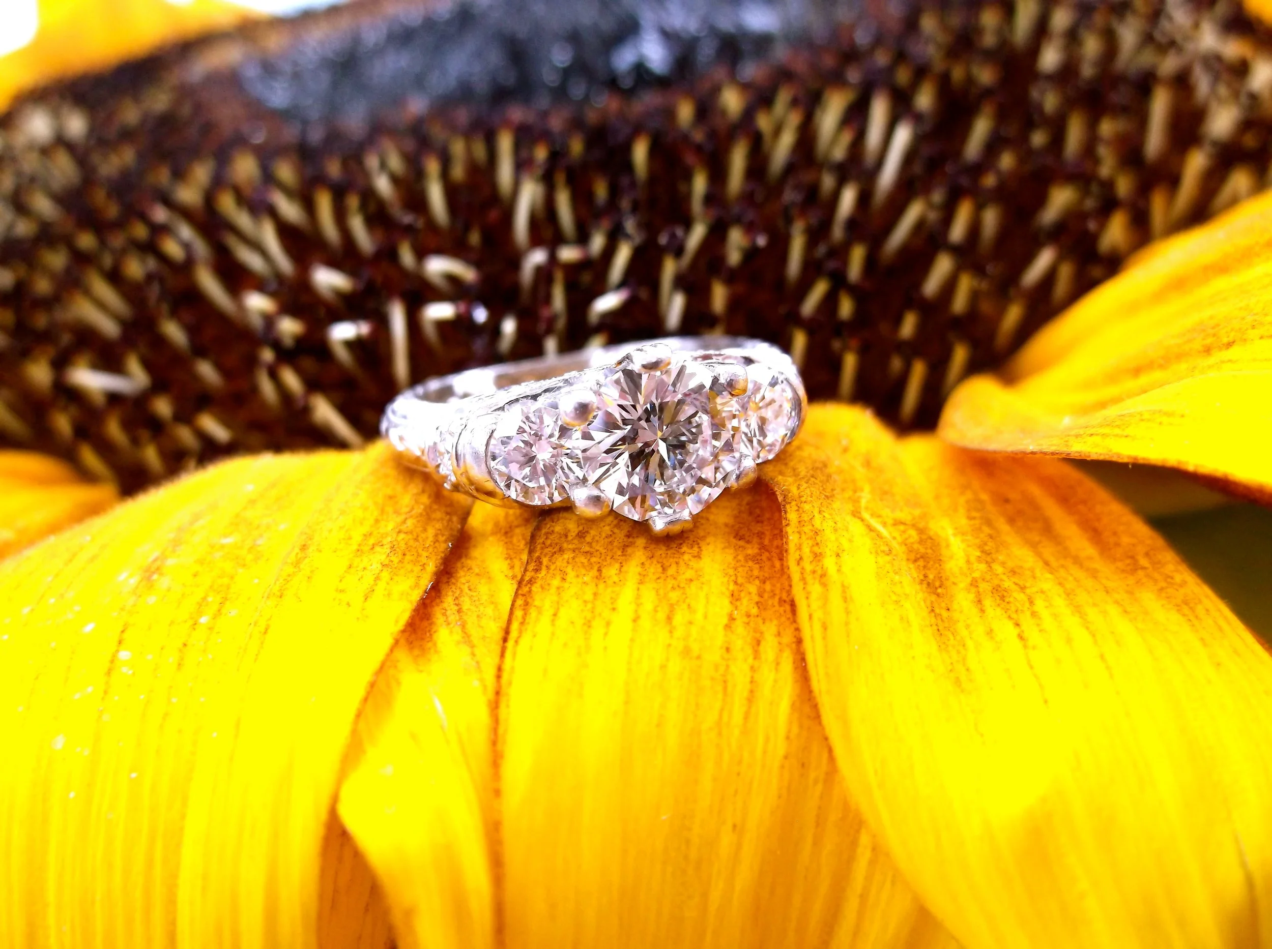 SOLD - Beautiful three stone diamond ring set in platinum! The center diamond is 1.06 carats with a 0.20 carat diamond on either side.