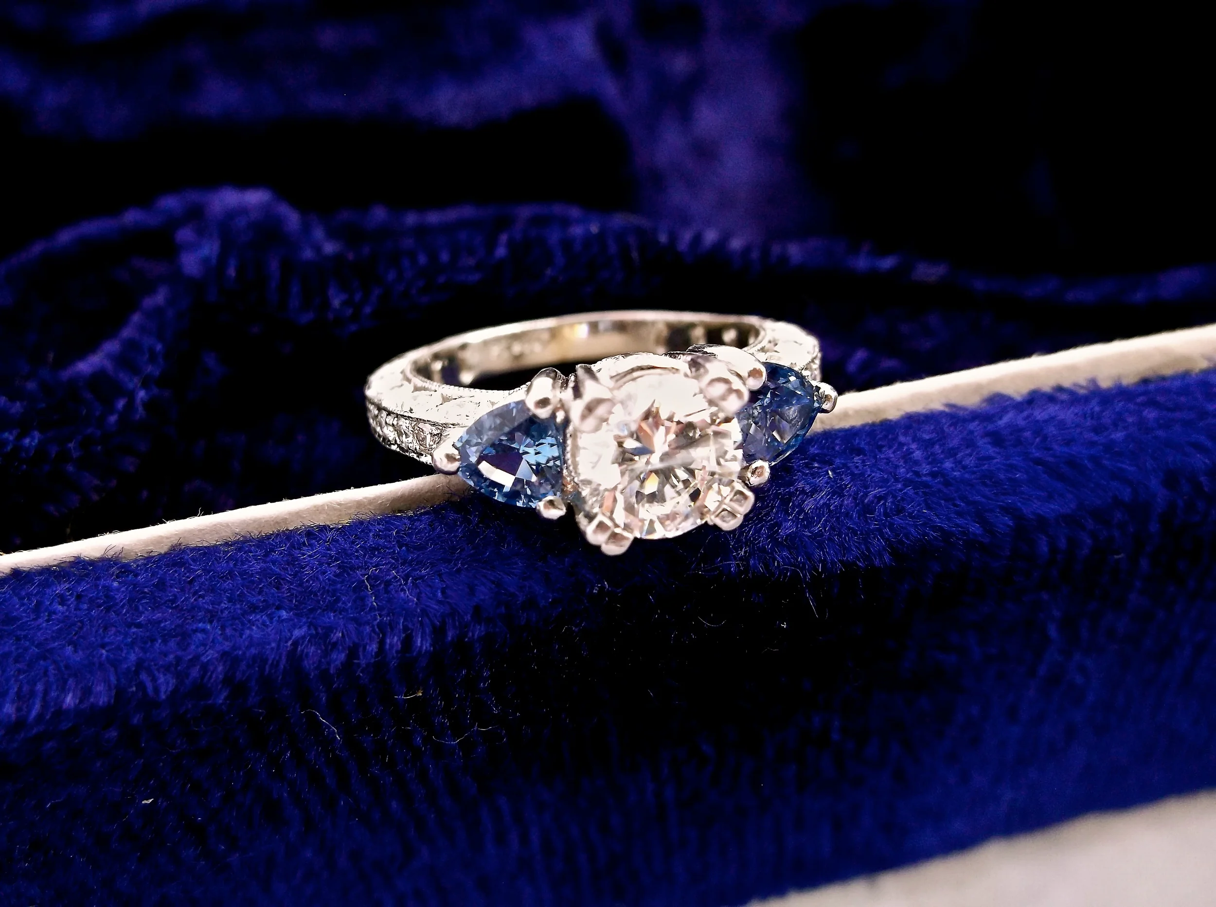 SOLD - Enchanting 0.94 carat diamond set in platinum with a sapphire on each side.