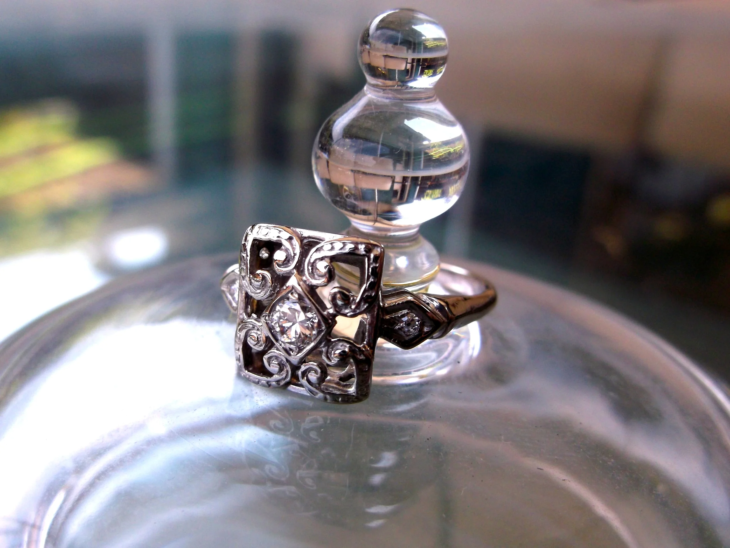 SOLD - Sweet Art Deco ring with a 0.10 carat Old European cut diamond in the center set in white gold.