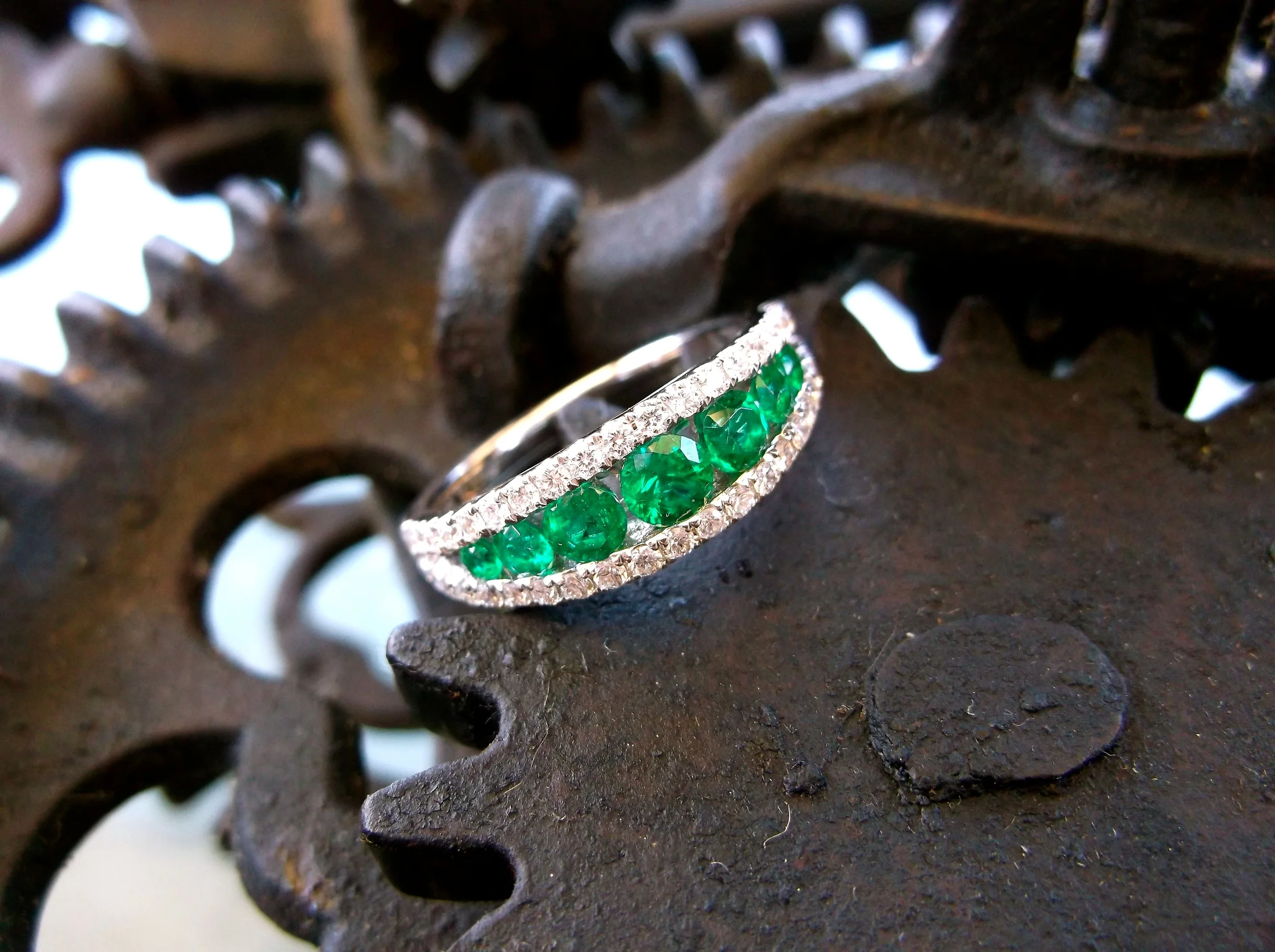 SOLD - Stunning emerald and diamond band set in white gold with 0.61 carats total weight in emeralds and 0.42 carats total weight in diamonds.