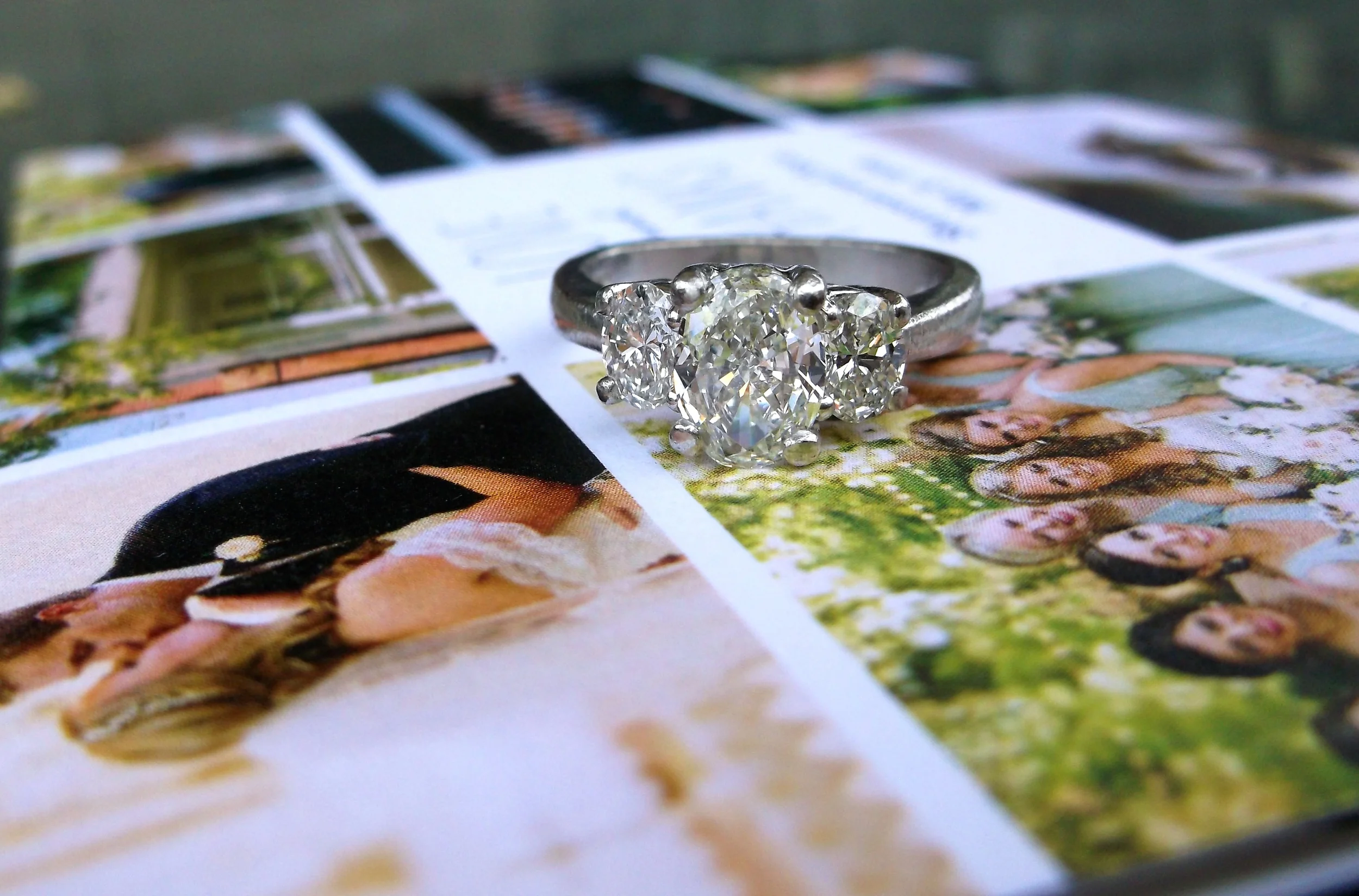SOLD - Gorgeous three stone oval diamond ring set in platinum with a 0.95 carat diamond in the center and a 0.33 carat diamond on either side. Thank you to Shannon and Scott for sending us such a lovely not with beautiful pictures from your wedding! We are honored to be a part of your story! 