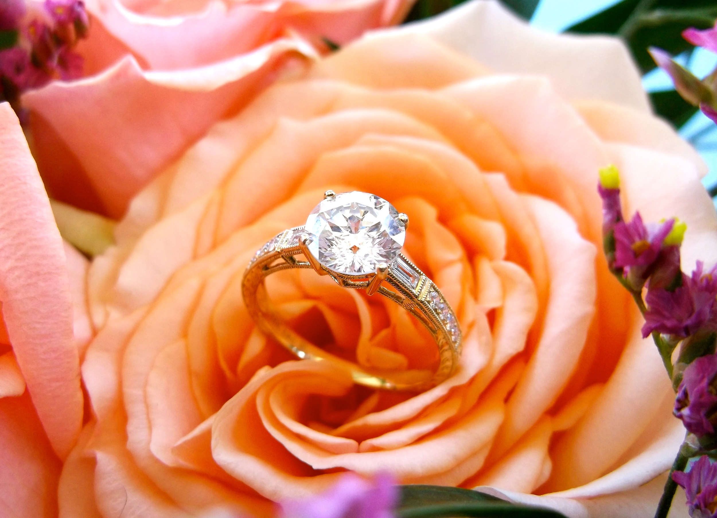 SOLD - Beautiful 1.53 carat diamond set in a dainty 18K yellow gold and diamond detail mounting. The center diamond is a "Sirius Star", a trademark cut done by our friends at Embee Diamonds, which features 80 facets (versus the traditional 58 of a round brillant diamond)! 