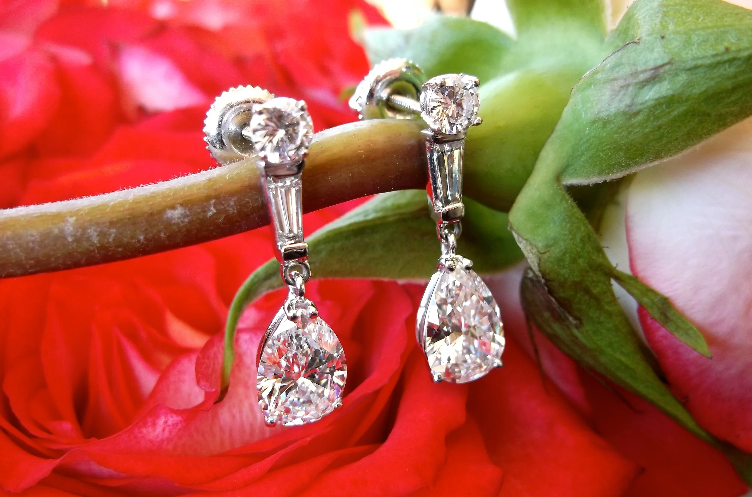 SOLD - Happy Valentine's Day! We are in love with this gorgeous pair of pear shaped diamond drop earrings featuring a 1.26 carat pear diamond dangling from each.