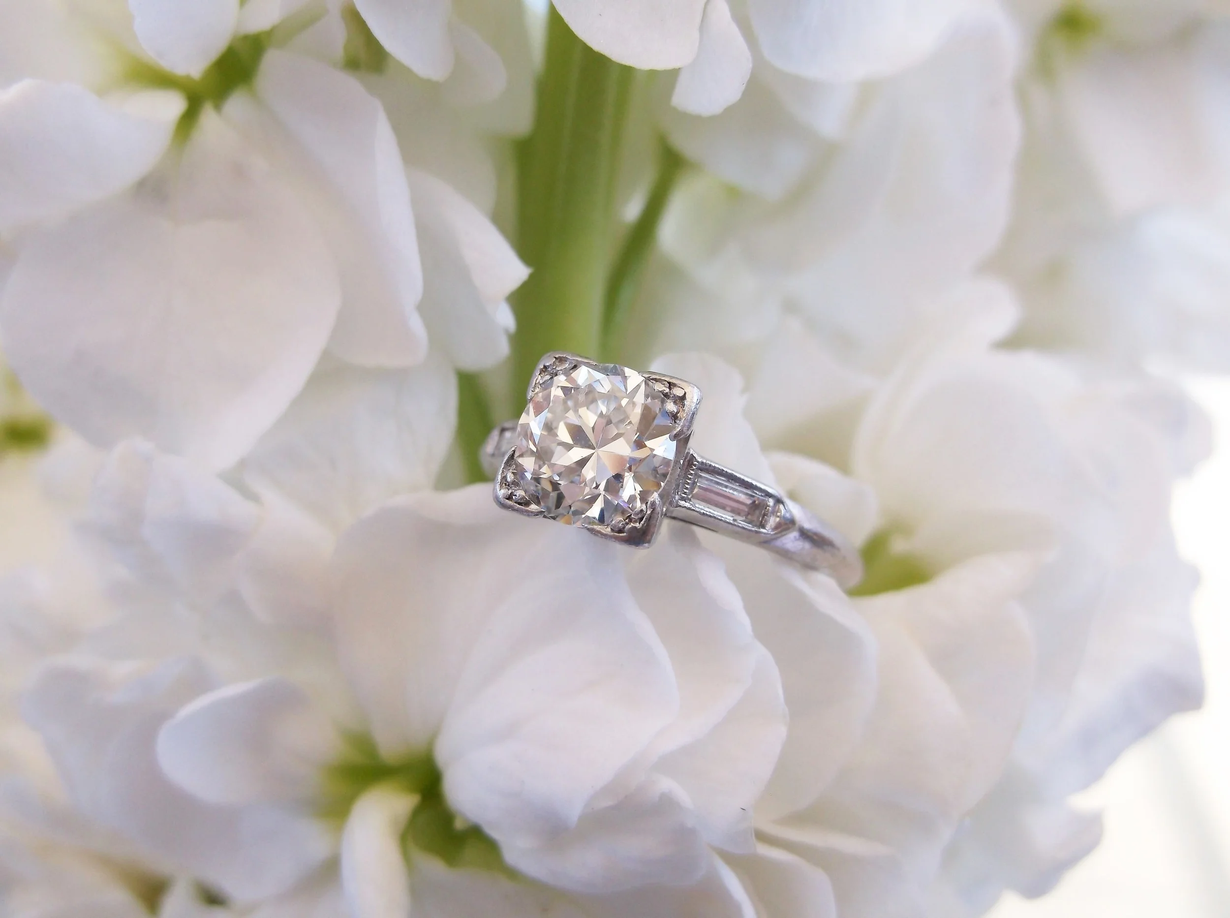 SOLD - A classic beauty! 1.16 carat Old European cut diamond with a baguette cut diamond on either side set in platinum. 
