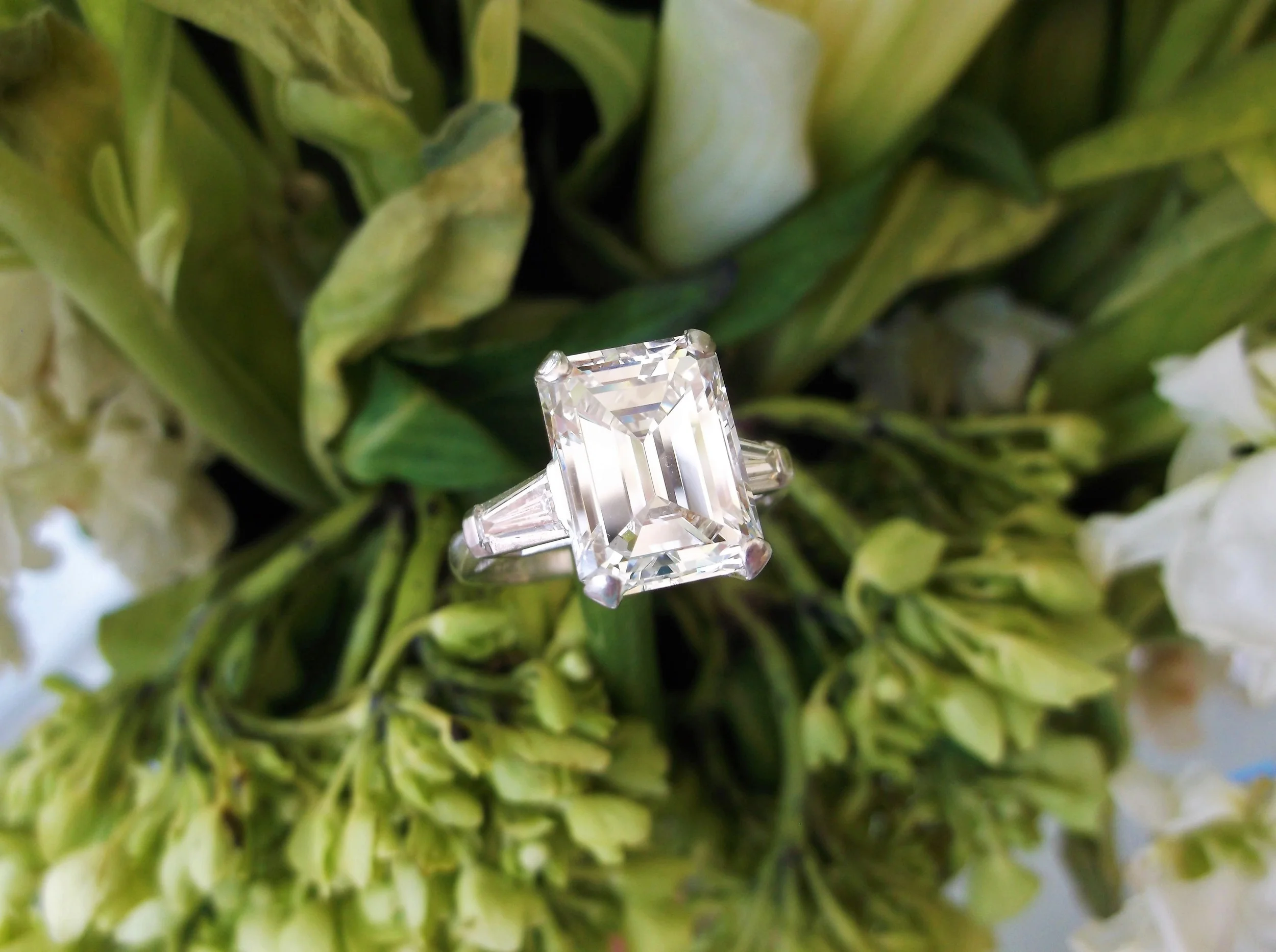 SOLD - Drop dead gorgeous 5.42 carat emerald cut diamond set in a classic baguette cut diamond and platinum mounting.