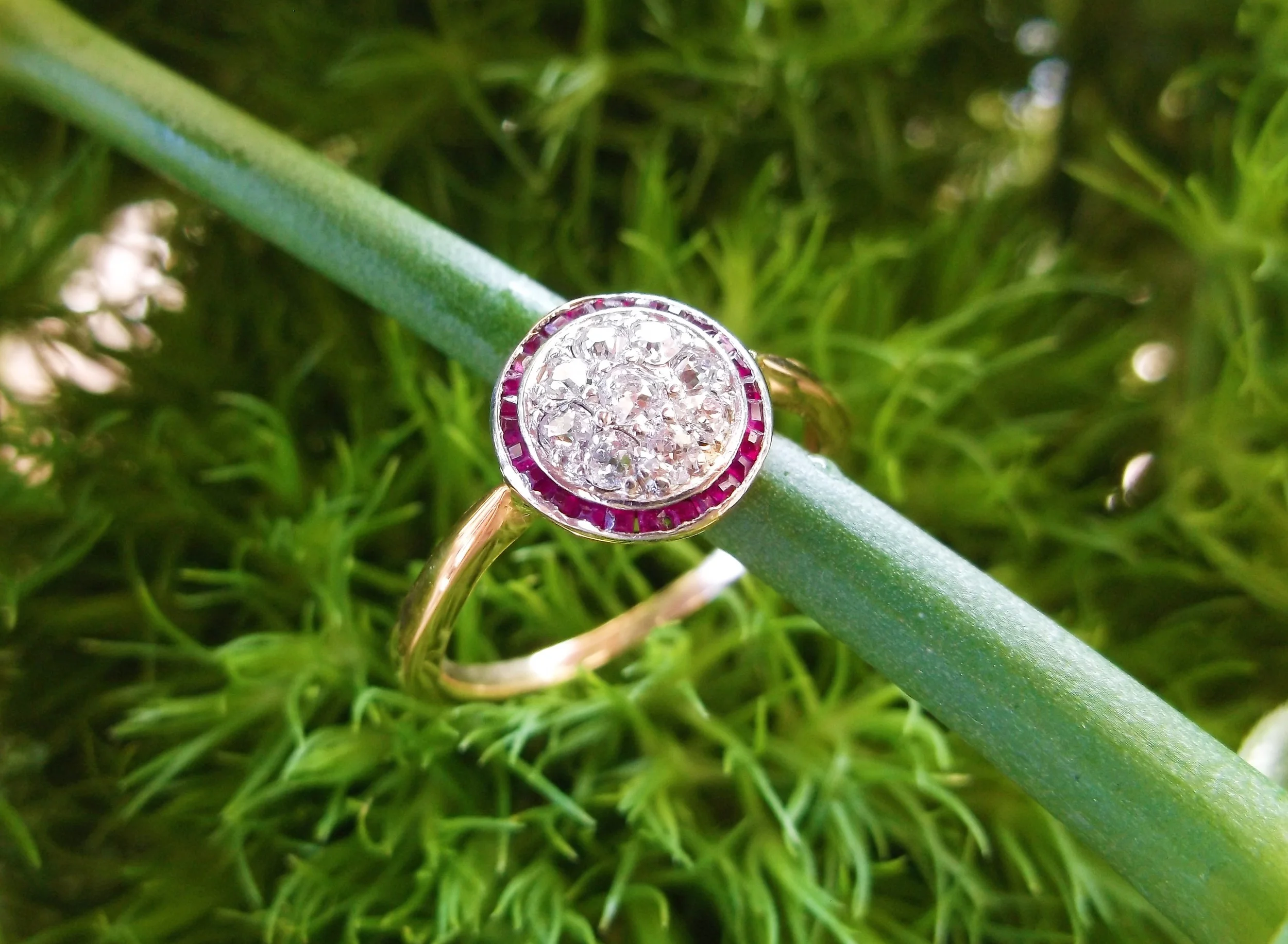 SOLD - Lovely Edwardian era, platinum topped gold, Old Mine cut diamond cluster ring surrounded by a halo of rubies (0.20 carats total weight in diamonds).