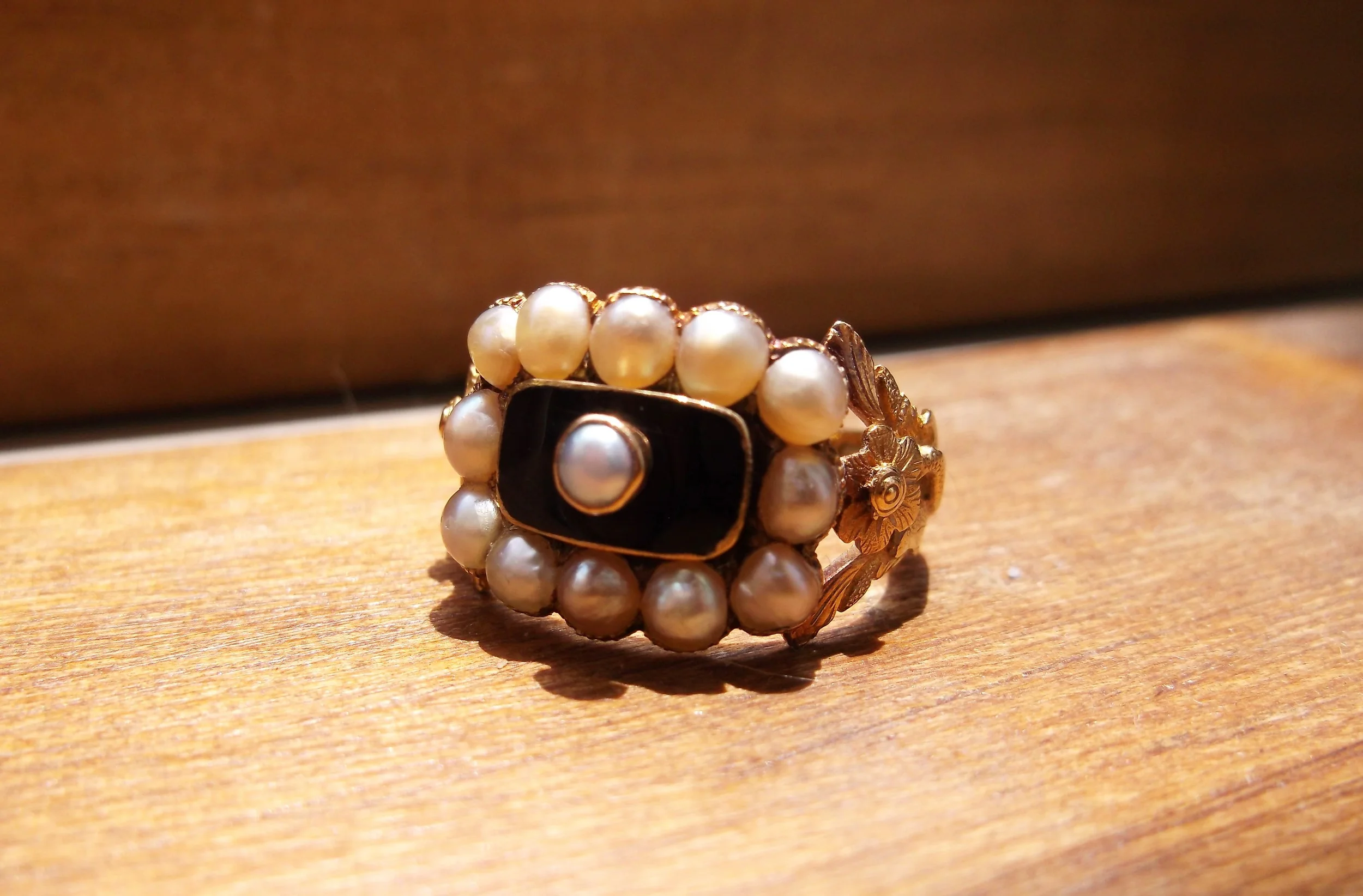 SOLD - Unique and beautiful 18K yellow gold, enamel and pearl ring circa 1832. This style of jewelry is referred to as "Memento Mori", a Latin phrase meaning "be mindful of death". Mourning rings were often presented to friends and family of the deceased and were often inscribed with the name, age, birth and death dates of the lost loved one. This ring is engraved on the inside, "Mr. Joseph Slack Jun, died 30 July, 1832 Aged 19." (See image below)