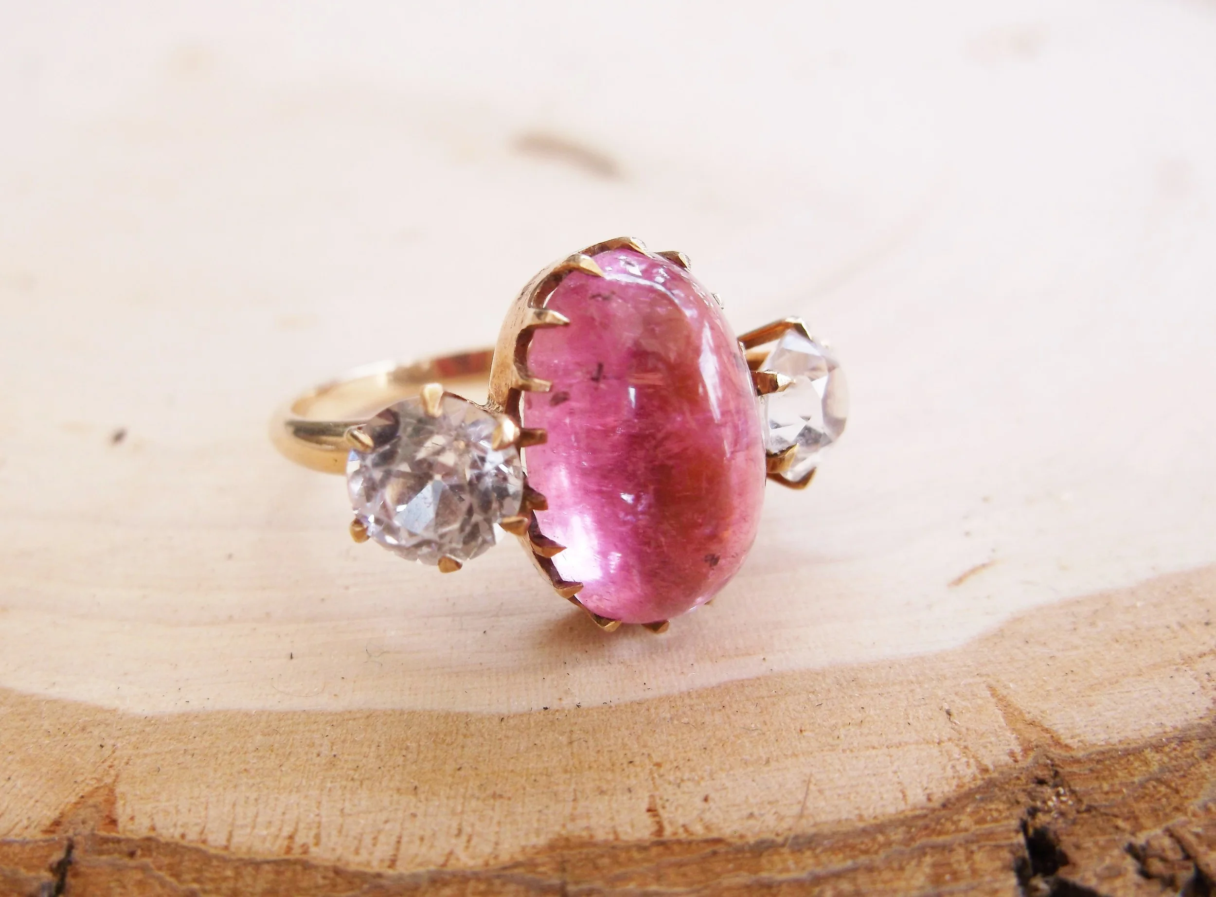 SOLD - Wonderfully unique 6.28 carat cabochon cut pink tourmaline ring with a 1.15 carat white sapphire on each side.