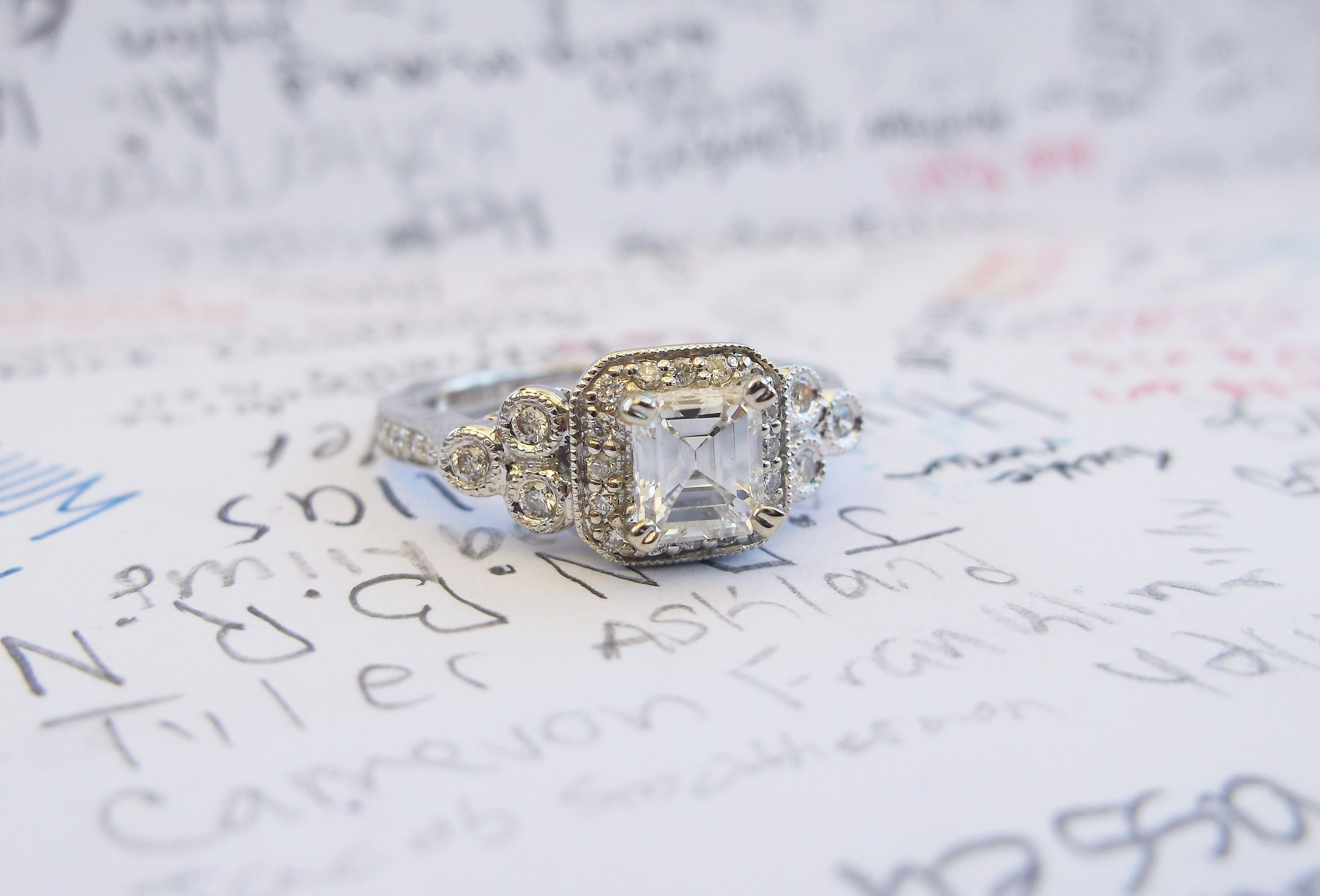 SOLD - Beautiful 0.49 carat emerald cut diamond set in a lovely white gold and diamond detail mounting.