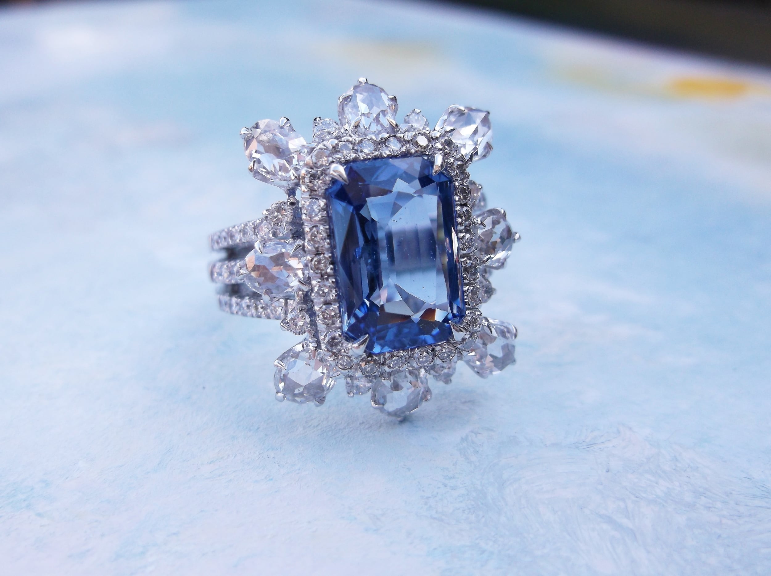 Beautiful 3.75 carat sapphire with approximately 2.00 carats total weight in rose cut and round brilliant cut diamonds set in 18K white gold.