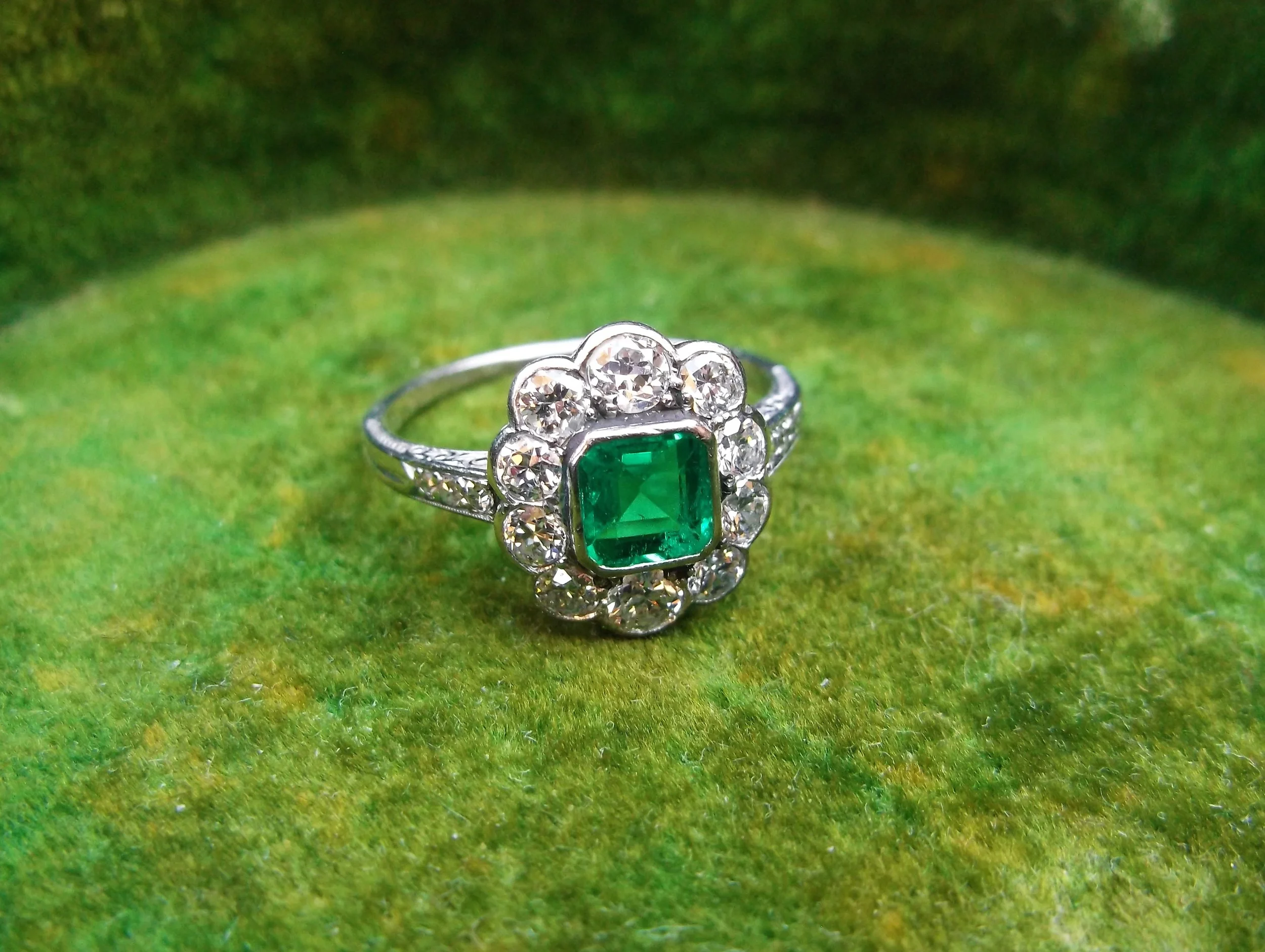 SOLD - Gorgeous 1920's 0.40 carat emerald surrounded by 0.75 carats total weight in Old European cut diamonds set in platinum.