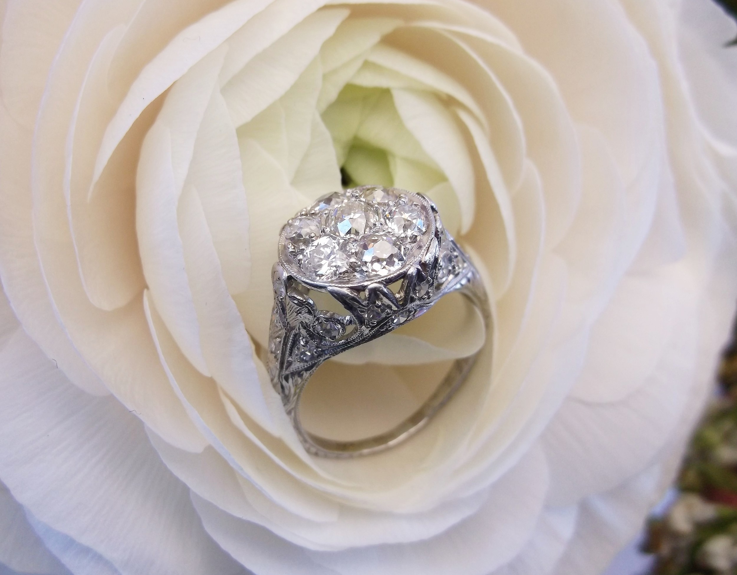 SOLD - Enchanting Art Deco diamond ring that features 1.35 carats total weight in Old Mine cut diamonds in the top cluster with beautiful filigree detail.