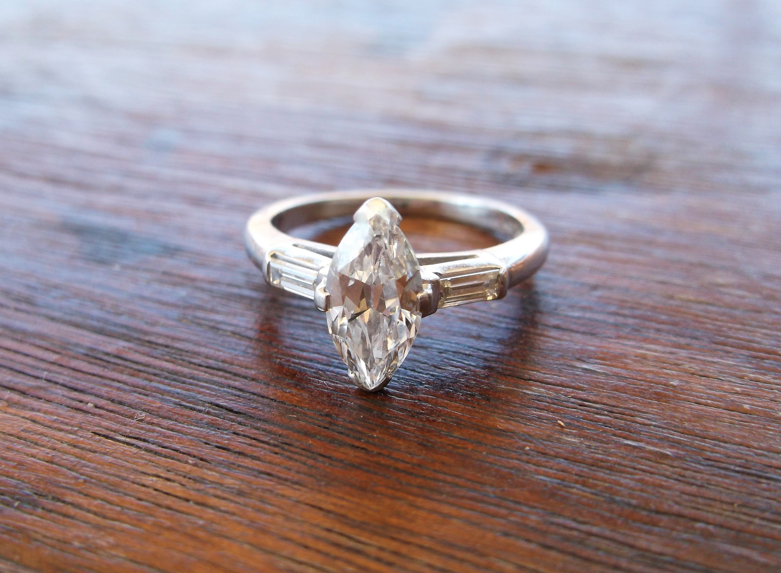 SOLD - Classic 1920's 0.93 carat marquis cut diamond with a baguette cut diamond on either side.