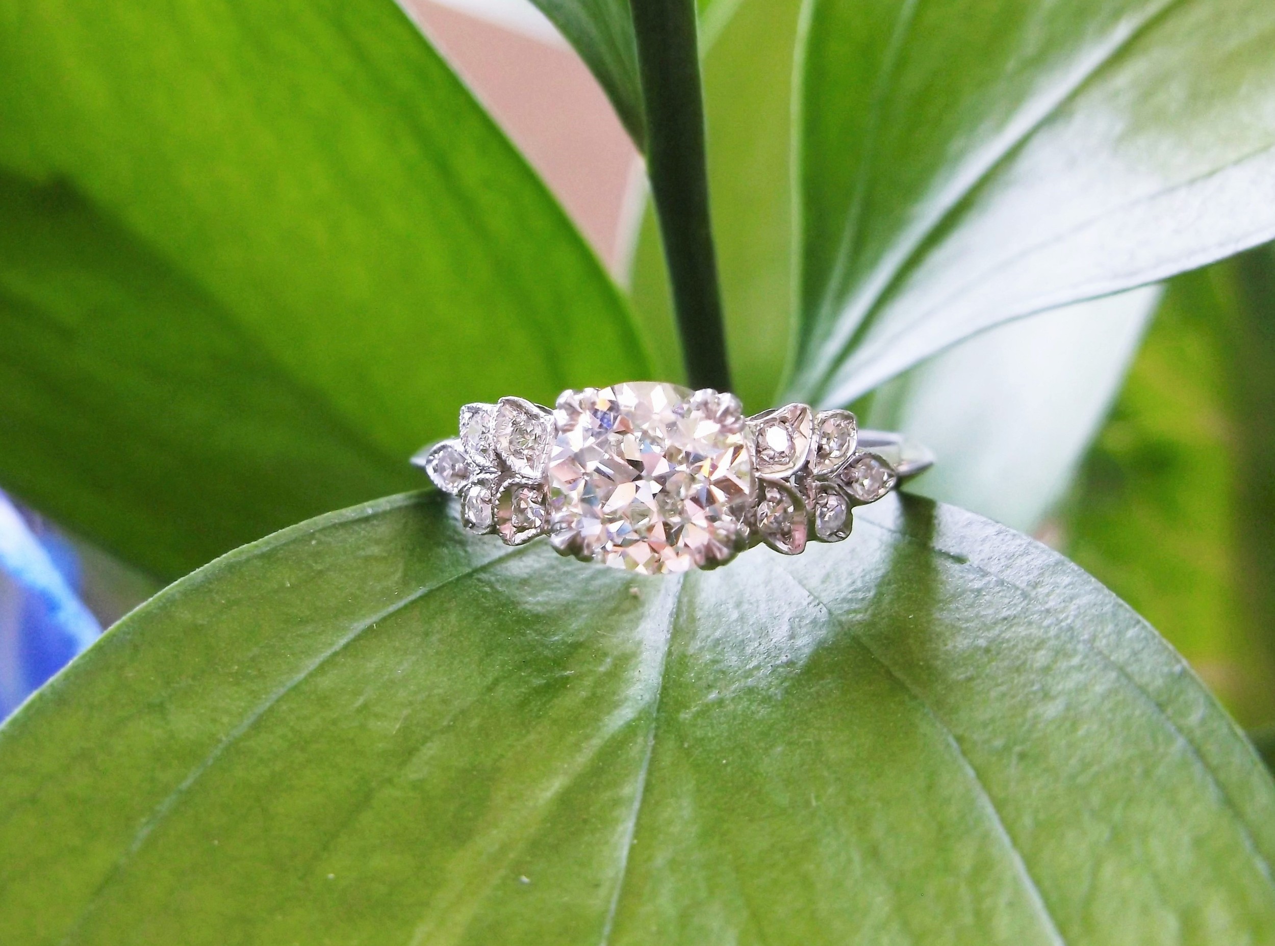 SOLD - Anticipating spring with this lovely 1.12 carat Old European cut diamond set in a leaf detail diamond and platinum mounting.