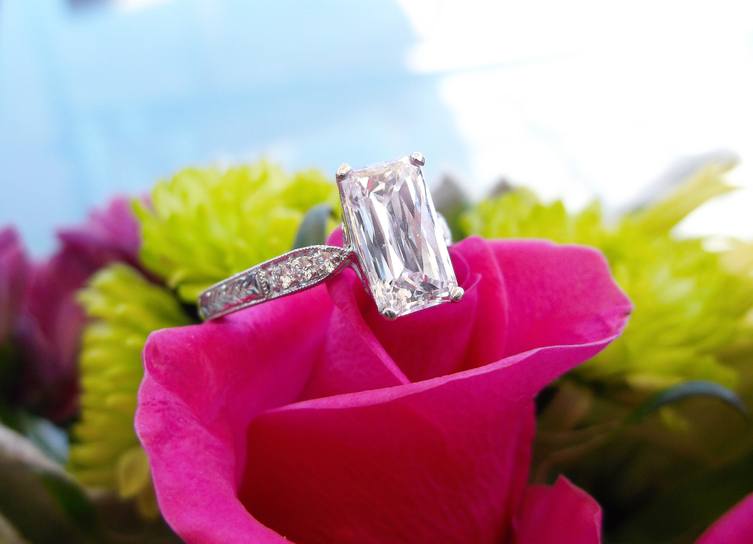 Mesmerizing 1.67 carat scissor cut diamond set in a beautiful diamond and platinum mounting. 