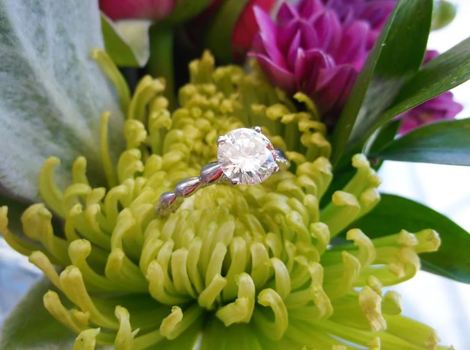 Gorgeous 1.30 carat round brilliant cut diamond in a beautiful white gold and diamond detail mounting.