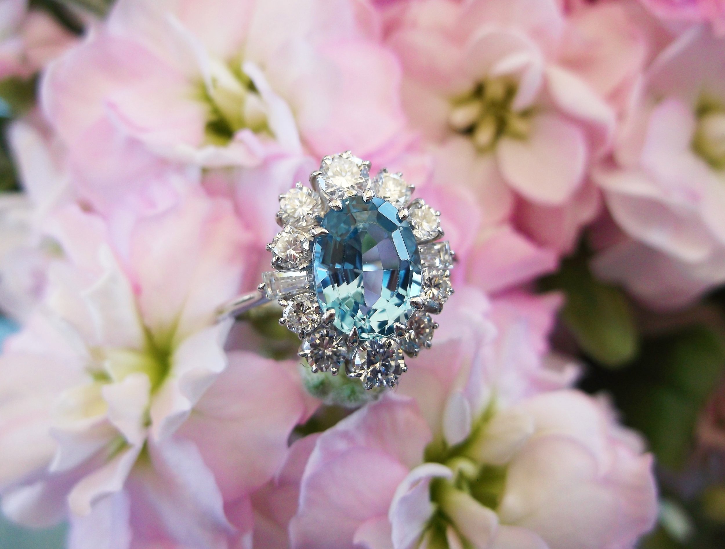 SOLD - Fanciful 1.75 carat aquamarine ring surrounded by 1.00 carat total weight in diamonds set in white gold.