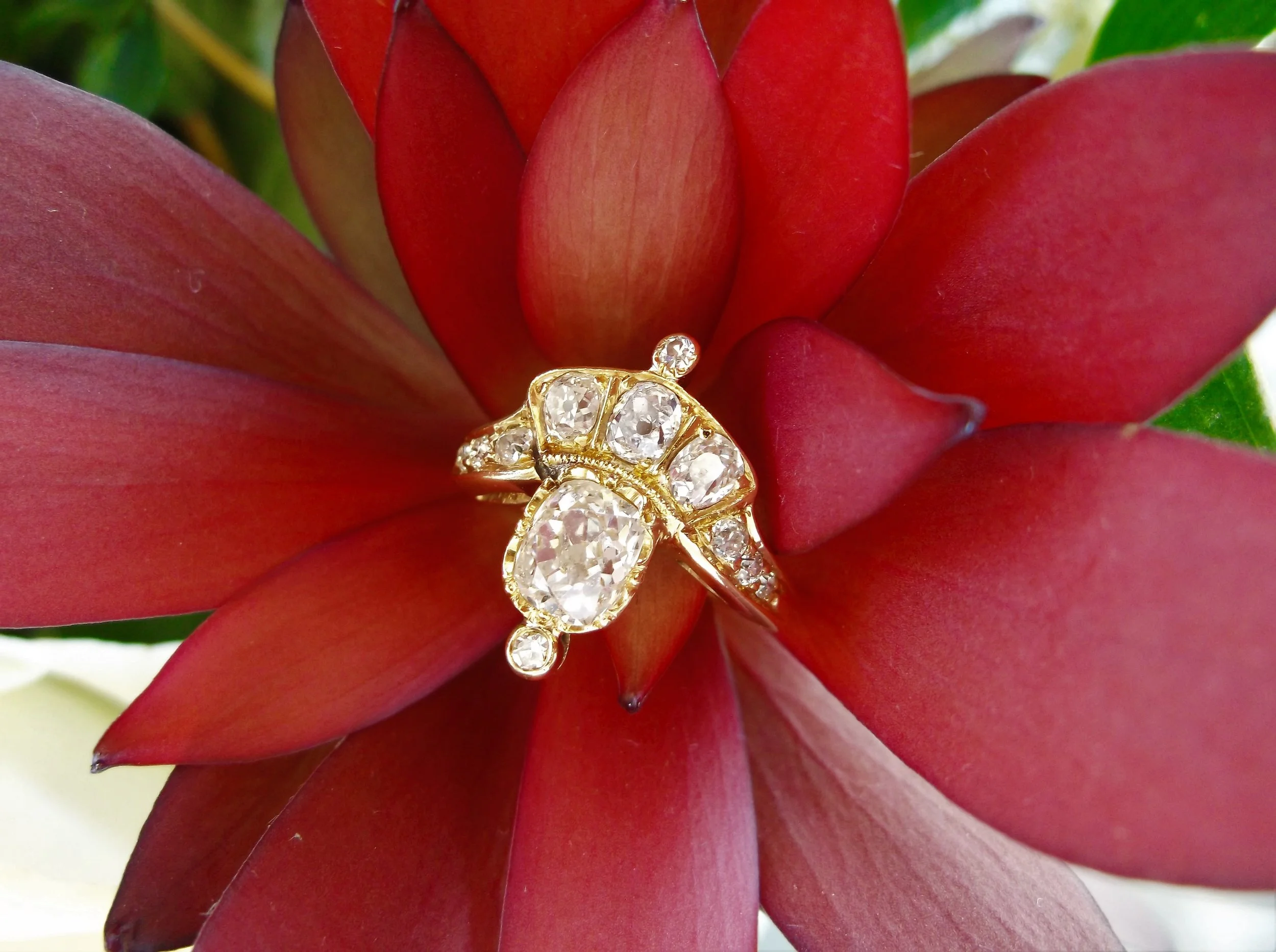 This noble 19th century tiara diamond ring is fit for a queen! It features a 0.95 carat Old Mine cut diamond surrounded by 11 smaller Old Mine cut diamonds set in yellow gold.