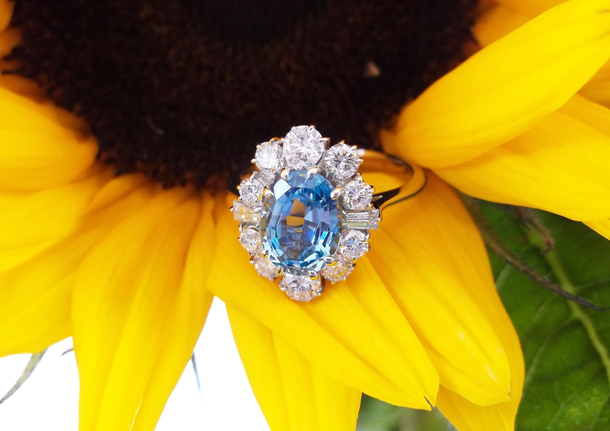 SOLD - Darling 1.75 carat aquamarine, surrounded by 1.00 carats total weight in diamonds.