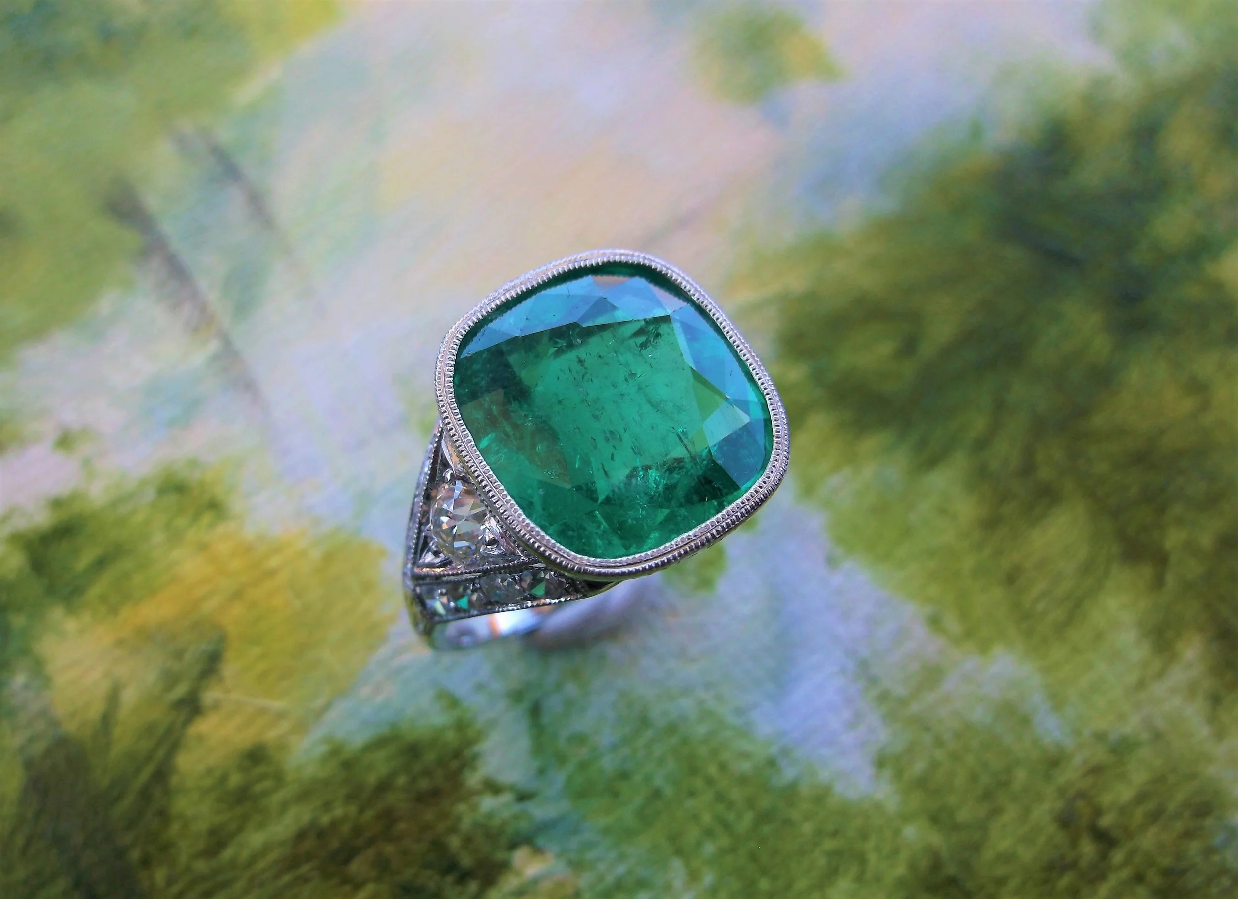 SOLD - Absolutely stunning 5.13 carat emerald set in a hand engraved milgrain bezel setting with Old Mine cut and single cut diamond details.