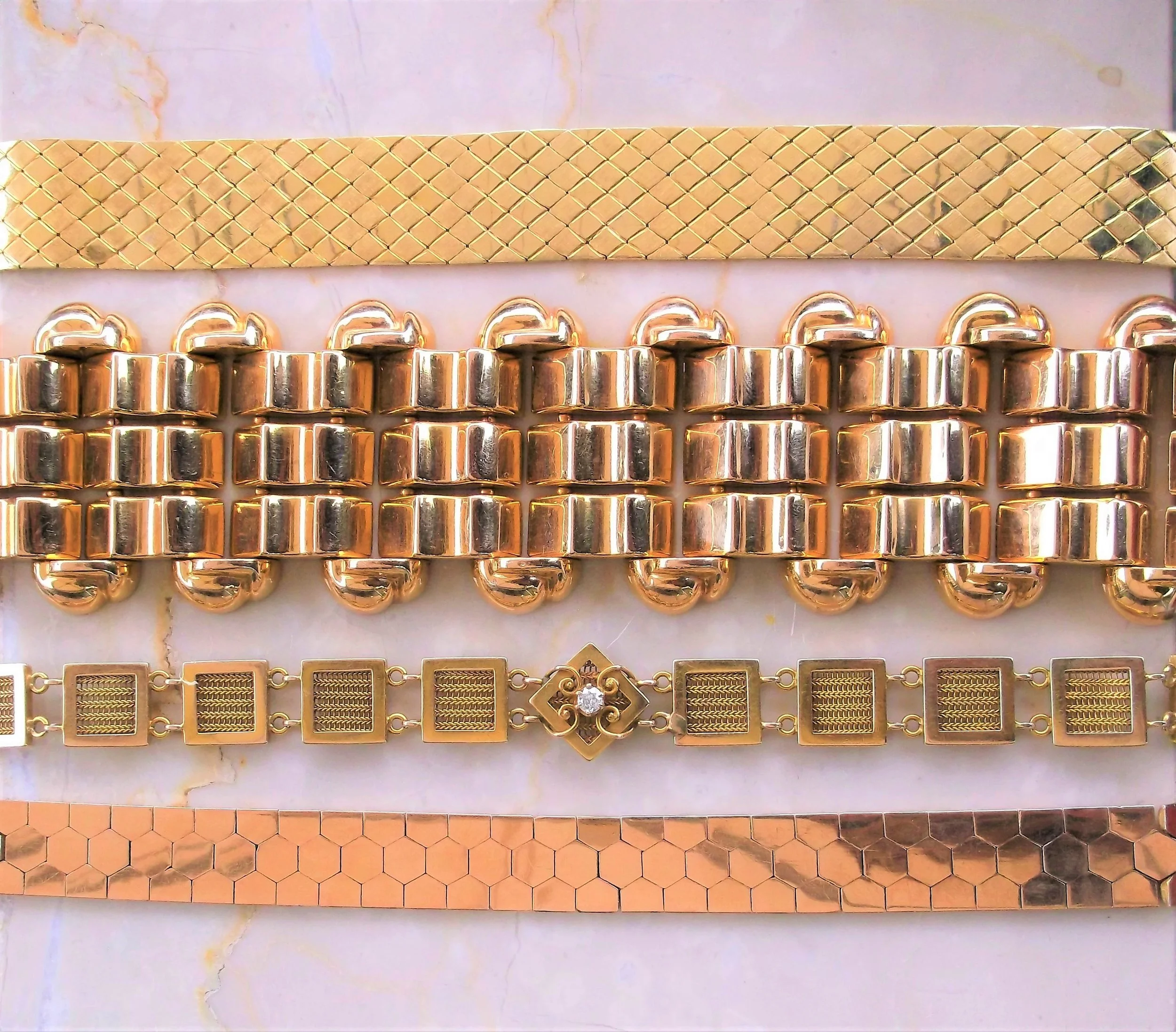 An array of bold yellow gold bracelets! Gorgeous on their own or stacked with others!