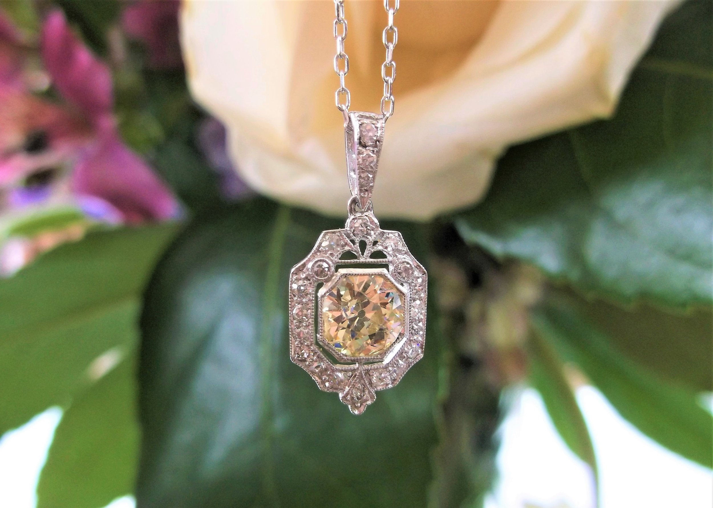 SOLD - Exquisite 1920's diamond and platinum pendant, set with a 1.00 carat Old European cut diamond in the center, surrounded by 0.45 carats total weight in Old Mine cut and single cut diamonds. 