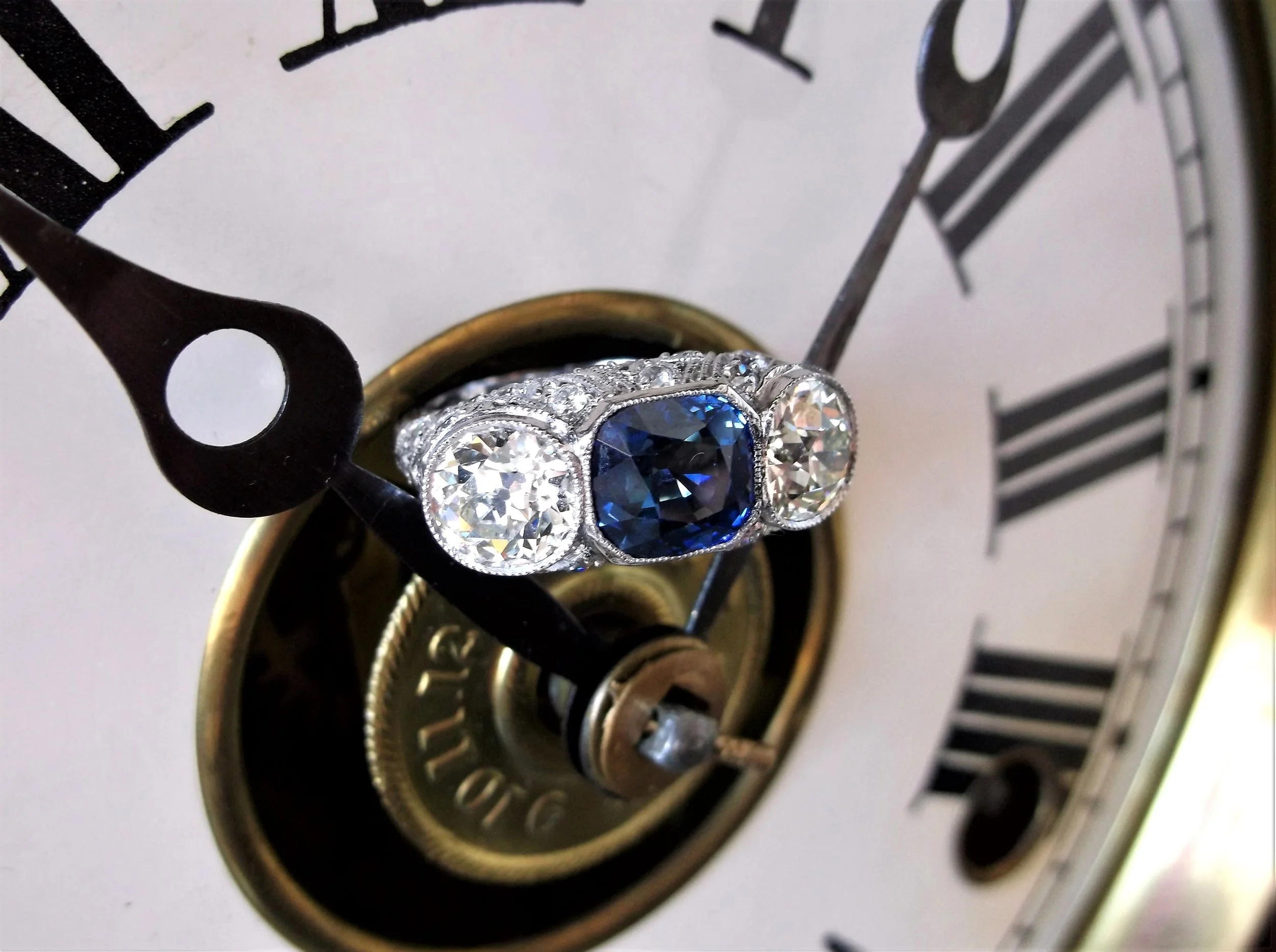 All original Art Deco ring featuring a 3.24 carat blue sapphire in the center, flanked on each side by one 1.30 carat Old European cut diamond with 1.00 carats total weight in Old Mine cut diamonds set into the platinum mounting. Shop this ring HERE