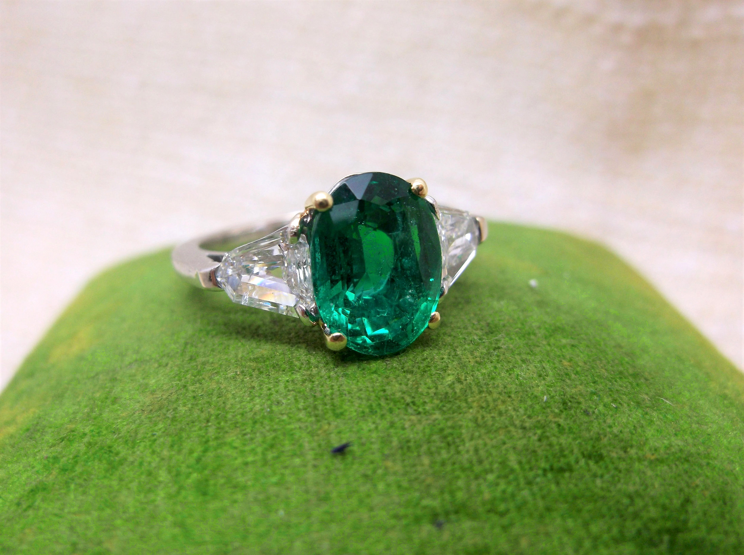 Pinch proof yourself this St. Patrick's Day with this jaw dropping 2.93 carat emerald ring with two gorgeous trapezoid cut diamonds on each side. Shop this ring HERE
