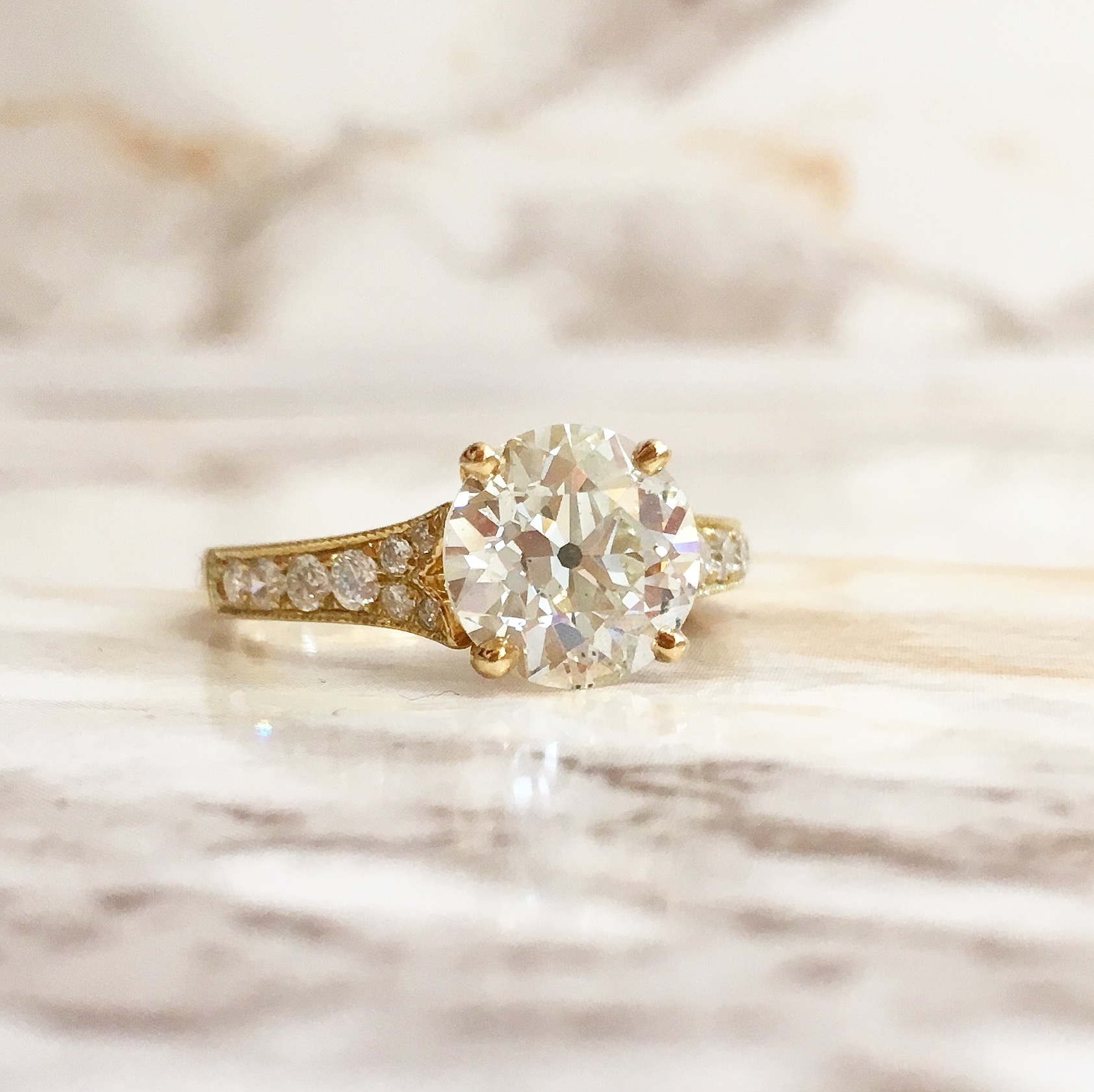 Beautiful 2.46 carat Old European cut diamond set in a yellow gold and diamond detail mounting. Shop this ring HERE