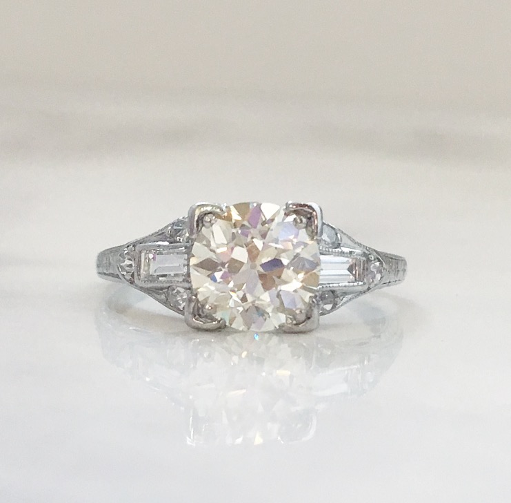 Elegant and timeless Art Deco platinum diamond ring featuring a 1.18 carat Old European cut diamond in the center with 0.40 carats total weight in accent diamonds. Shop this ring HERE