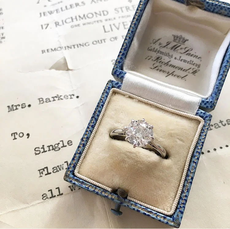 Meet Mrs. Barker. Why the name, you ask? This 2.00 carat Old European cut beauty was purchased in 1940, by Mrs. Barker in Liverpool, England. Here, the ring is pictured with the original receipt in the original box with the original care card, addressed to Mrs. Barker. During that time, Liverpool was in the thick of World War II. It was targeted by the Germans - and badly hit - because it was a port town. Although the heaviest bombings occurred during the later part of the year, as well as the following year, there is no telling what this ring, and Mrs. Barker endured. Shop this ring HERE