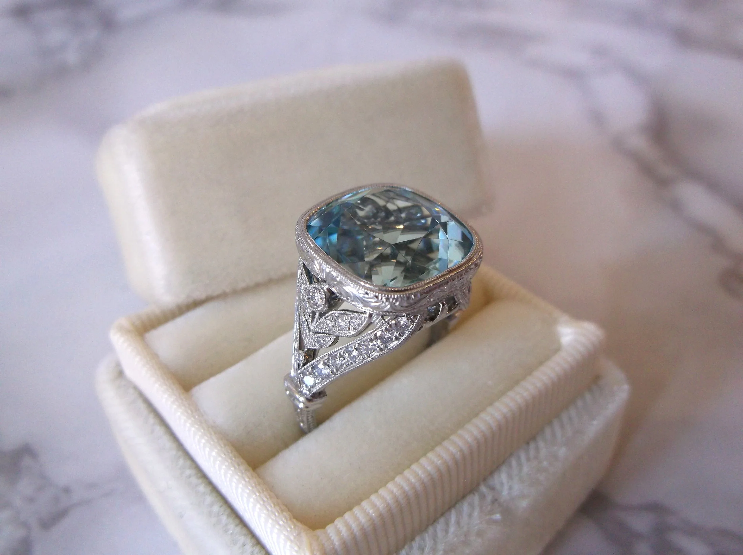 The perfect something blue! The center 9.73 carat aquamarine was originally set in an Edwardian era broach, and now finds its new home in this fabulous hand crafted platinum and diamond mounting with gorgeous hand engraved details. Shop this ring HERE