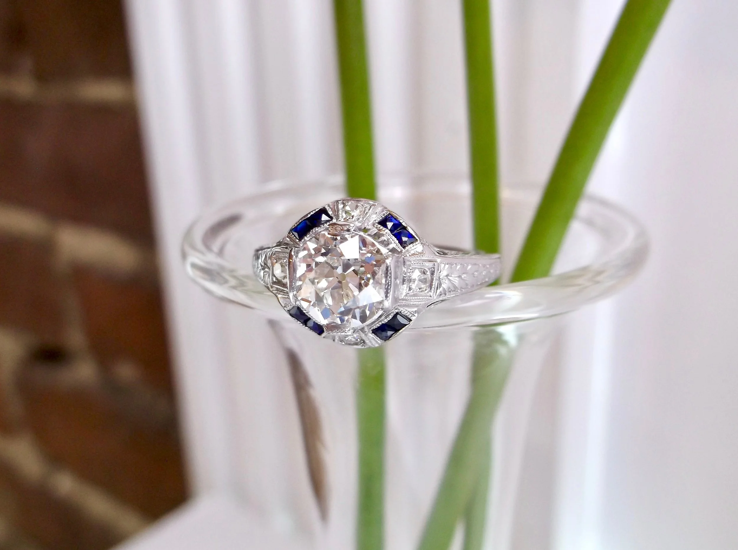 It's all in those eye catching sapphire details with this gorgeous 1930's diamond ring! The ring features a center 1.40 carat Old European cut diamond, beautifully complimented by 0.12 carats in accent sapphires and 0.10 carats in accent diamonds, all set in platinum. Shop this stunning ring HERE