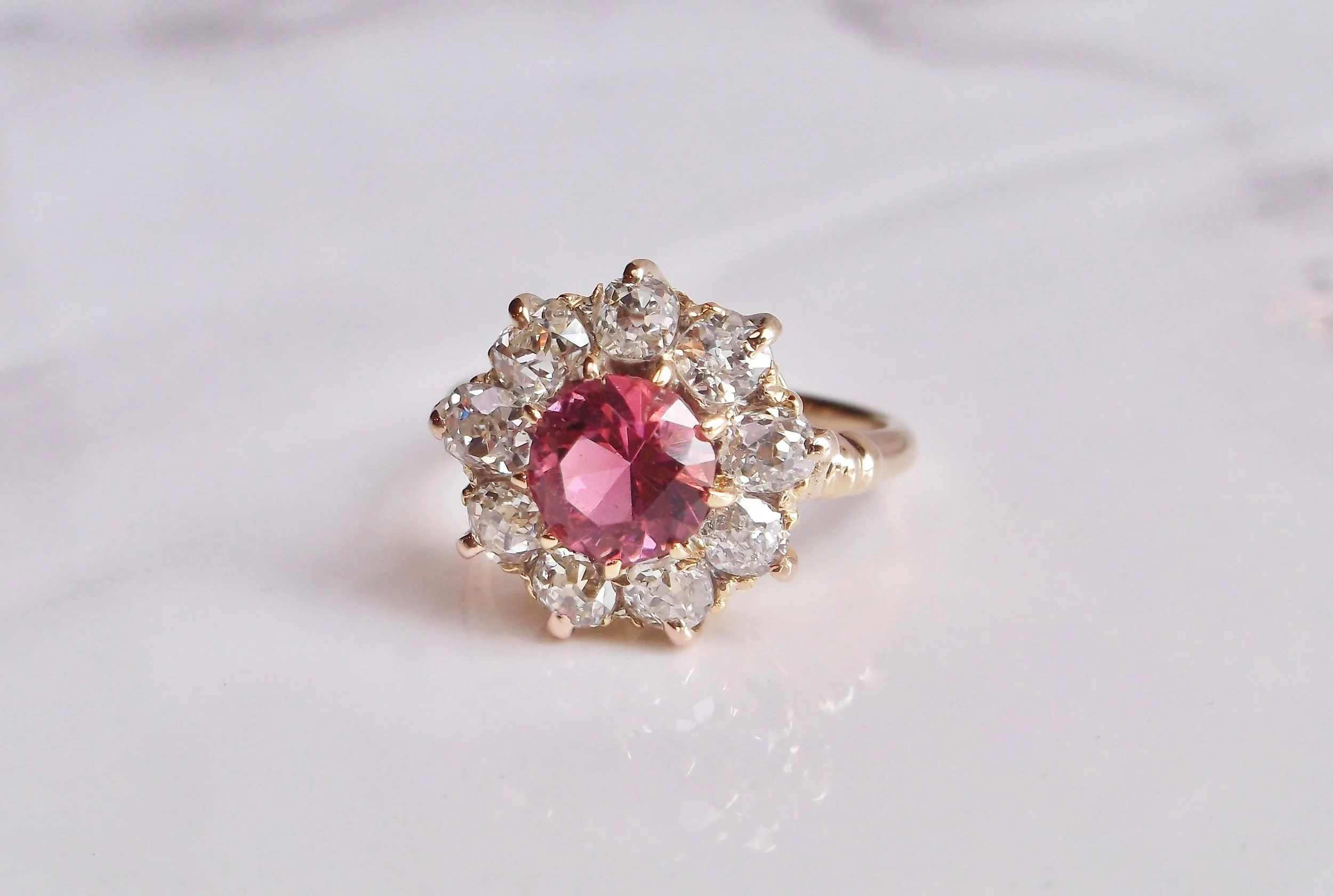 Add a pop of pink to your wardrobe with this lovely pink tourmaline, Old Mine cut diamond and yellow gold ring! The ring features a center round brilliant cut pink tourmaline, surrounded by 2.00 carats in Old Mine cut diamonds. Shop this beautiful ring HERE