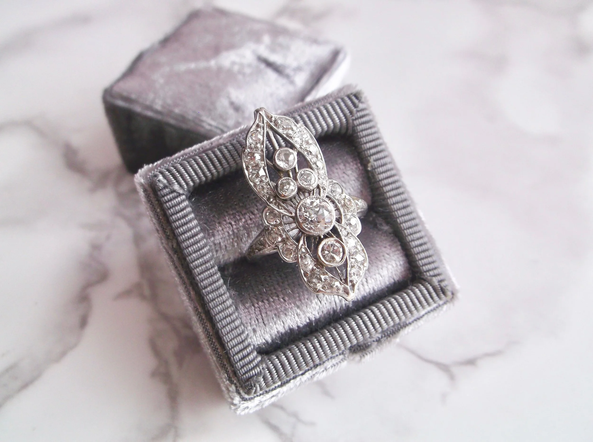 Intricate 1920's elongated diamond and platinum ring featuring 1.38 carats in Old European cut diamonds. Shop this beauty HERE