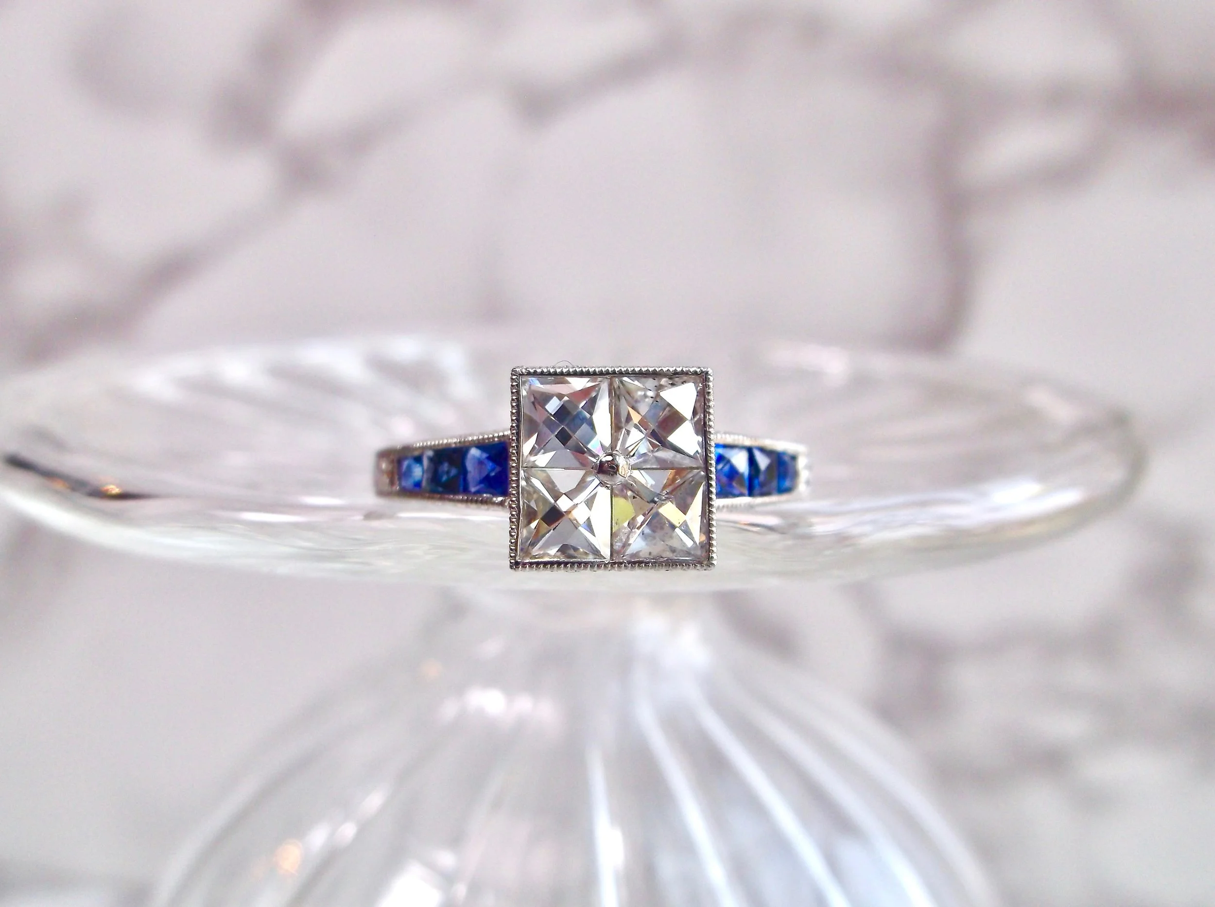 Oh my! We are so in love with this Art Deco inspired French cut diamond and blue sapphire ring! You must click the link below to see all of the hand engraved details on the platinum mounting! Shop this beauty HERE . 