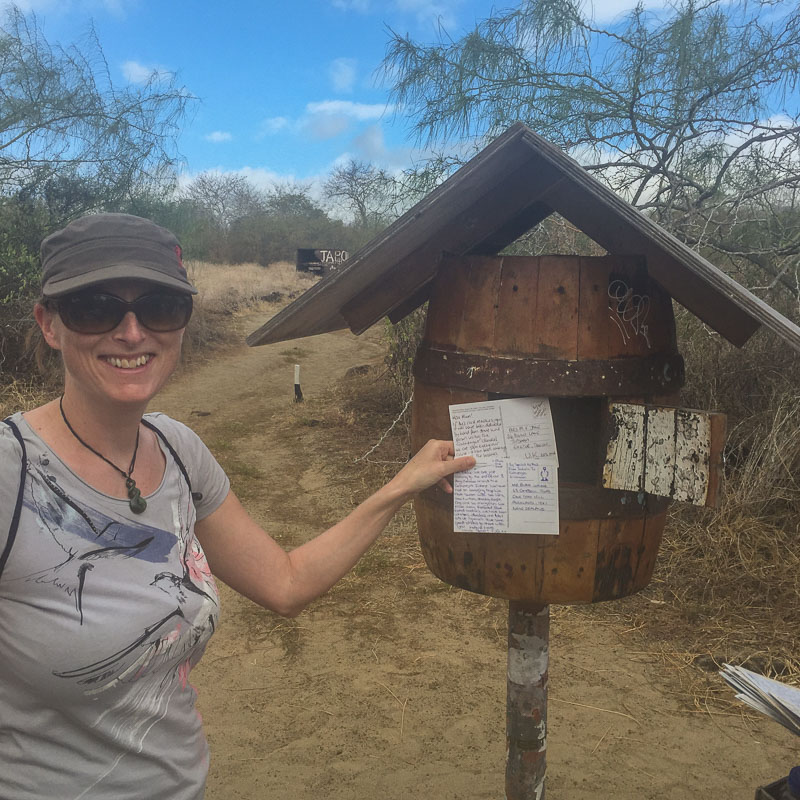 julie_posts_postcards_at_floreana_post_box_galapagos.jpg