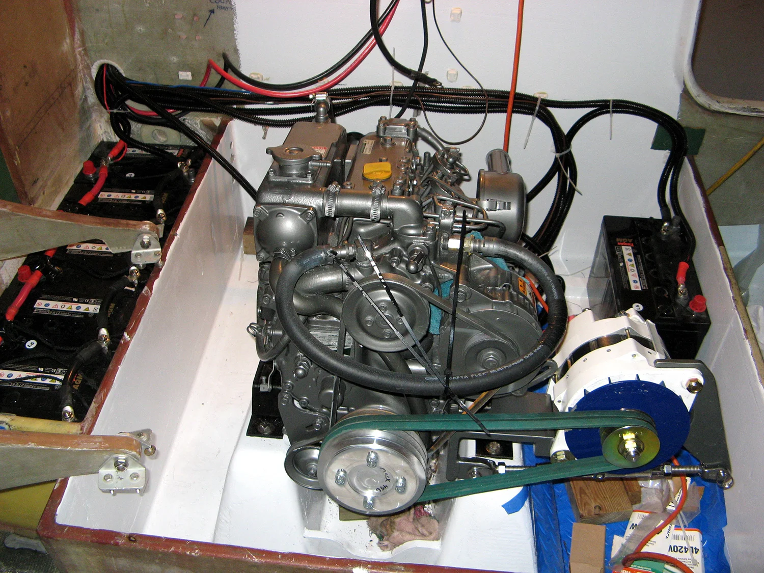A new engine was installed, with high-output
charging system, wiring, switches, and monitors. All of this equipment
is chosen with keeping weight down firmly in mind. Here is the new engine
with high-output charging and all electrical systems installed.