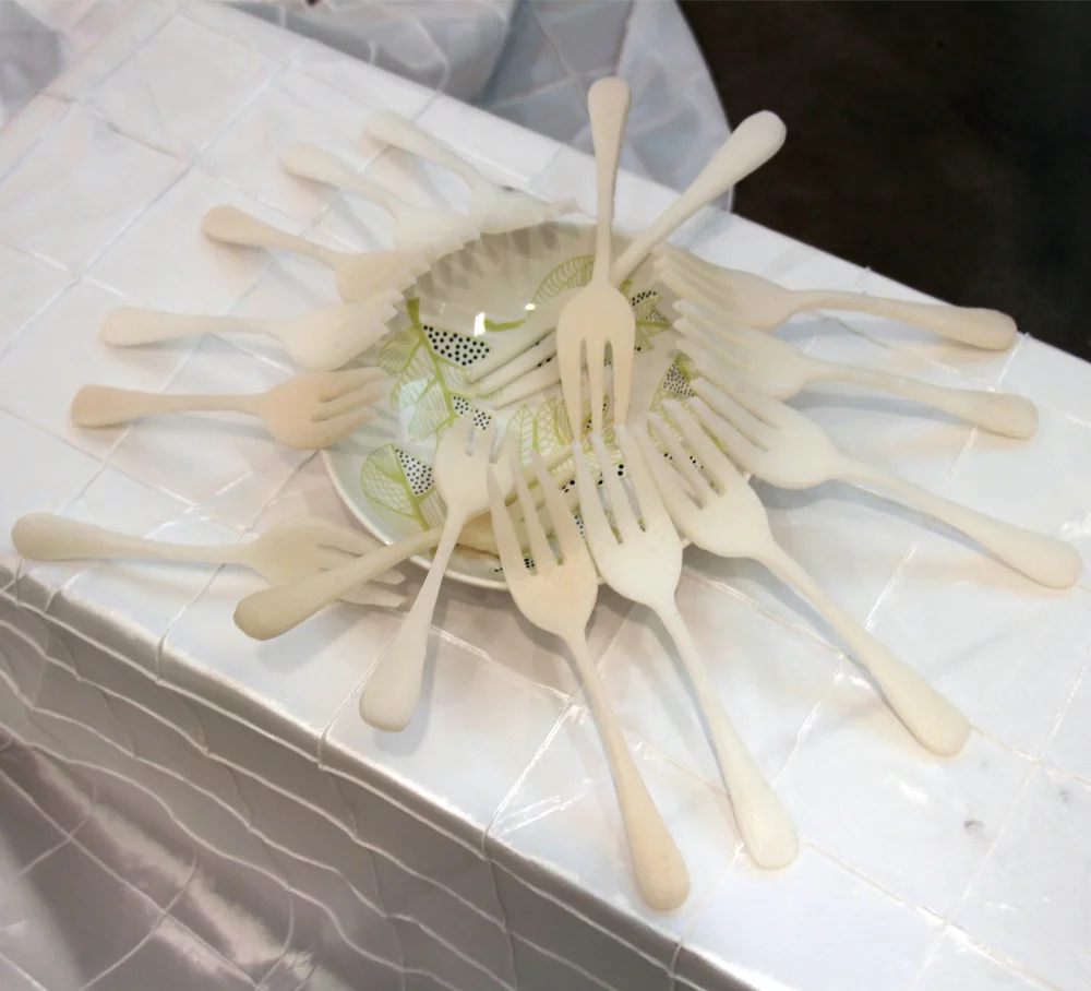 Title: Empty Course: Elements of Sculpture Unit: Multiples… Multiplying! Student: Yachen Wang Media: Cast Wax, Table Settings Dimensions: 18” x 24” x 24” Date: Spring 2017 Brief Description: Wang wanted to discuss the disparity between global mass production and global hunger. She did so by producing multiples of forks and then placing them on an empty bowl.