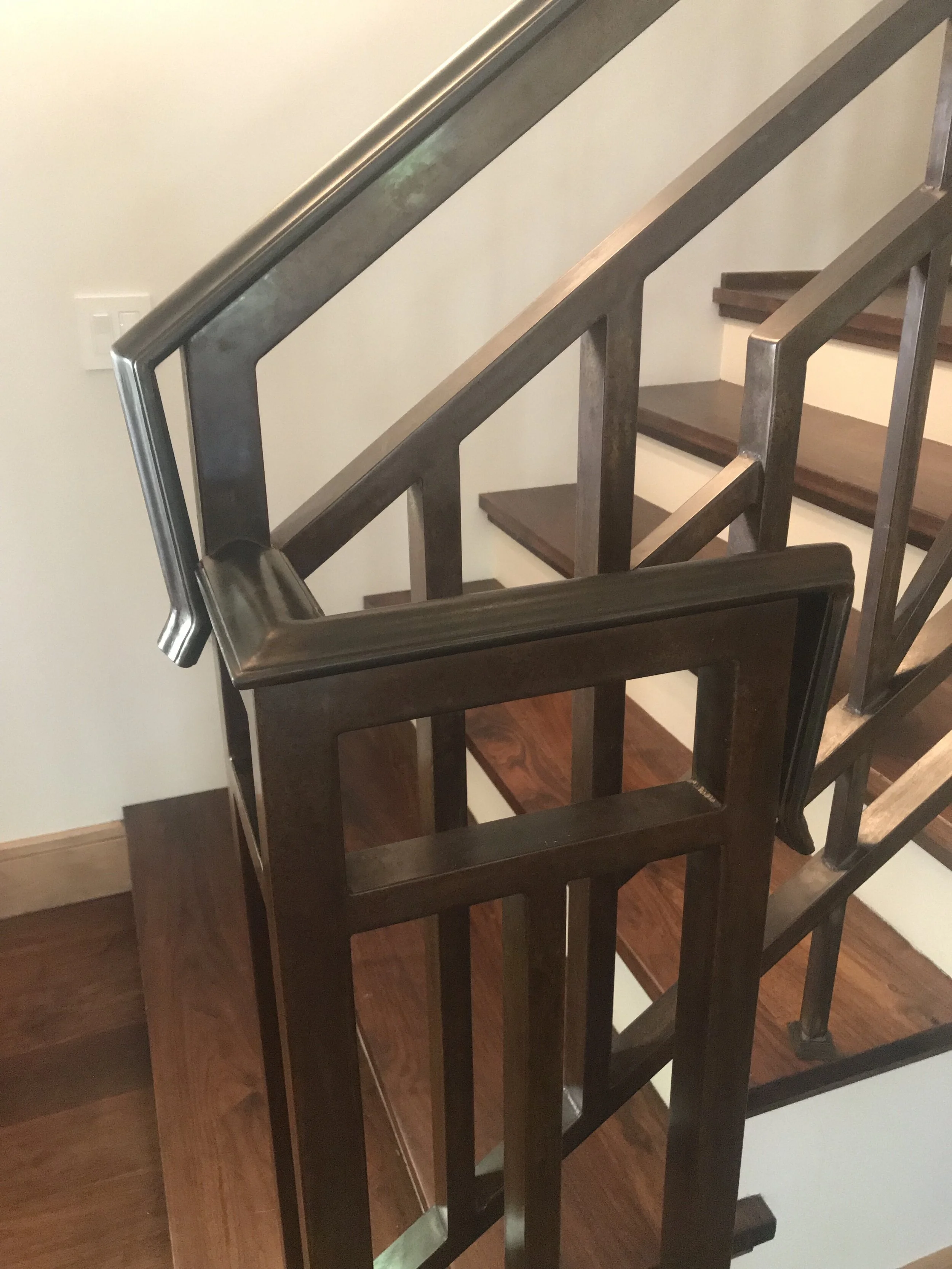 Custom, tig welded steel railing with patina and wax finish