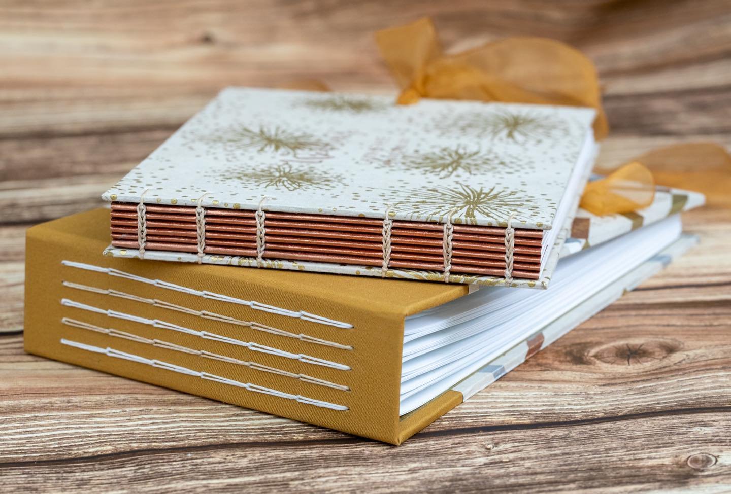 A photo album and guest book set in gold, white &amp; copper.
.
#bookbinding #handbound #etsywedding #weddingguestbook #weddingalbum #weddinggift #handmadewedding #copticstitch #copticbinding #weddingstationery