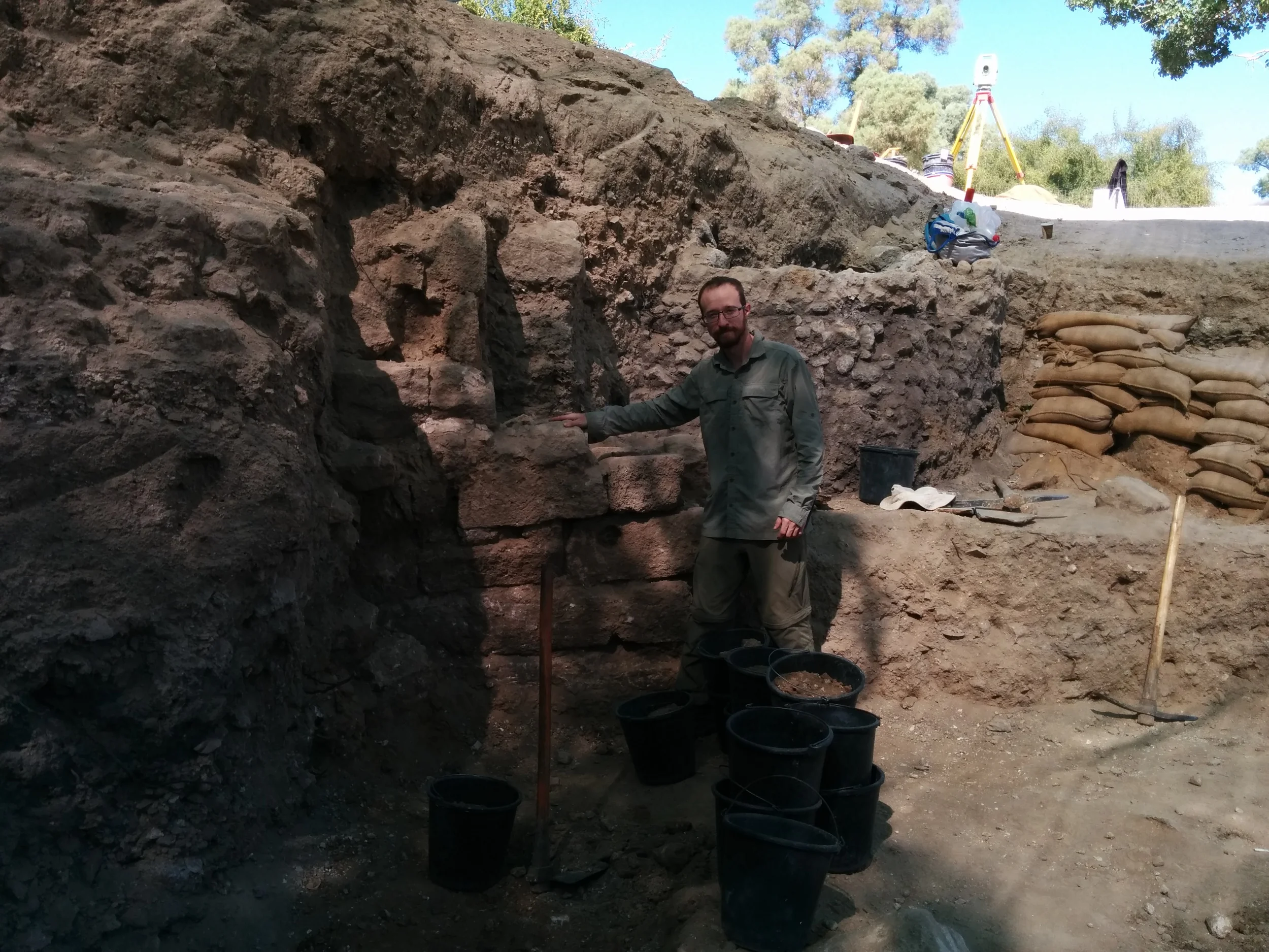 Ben standing next to a new wall/pier uncovered during excavation